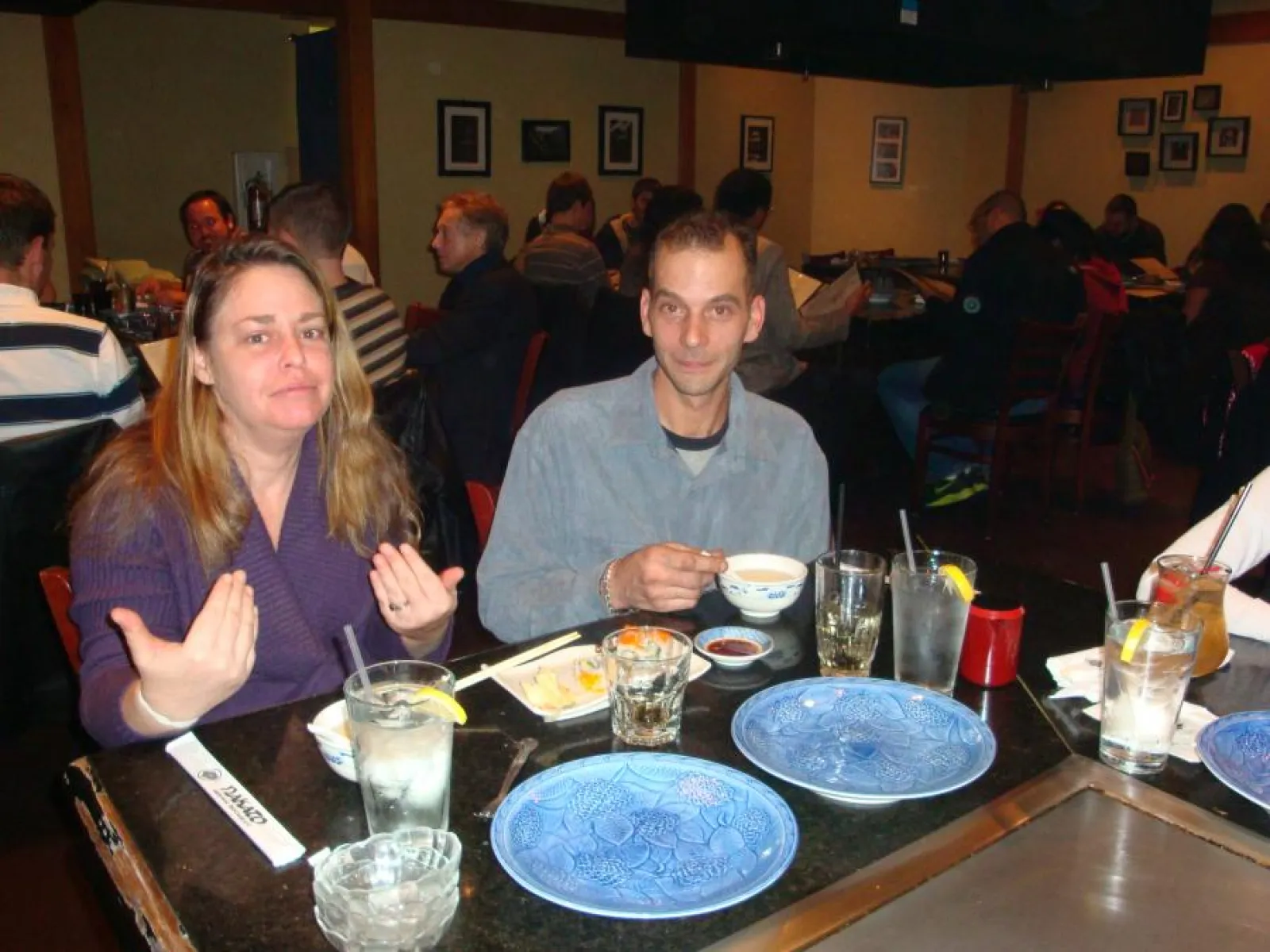 a group of people sitting at a table in a restaurant