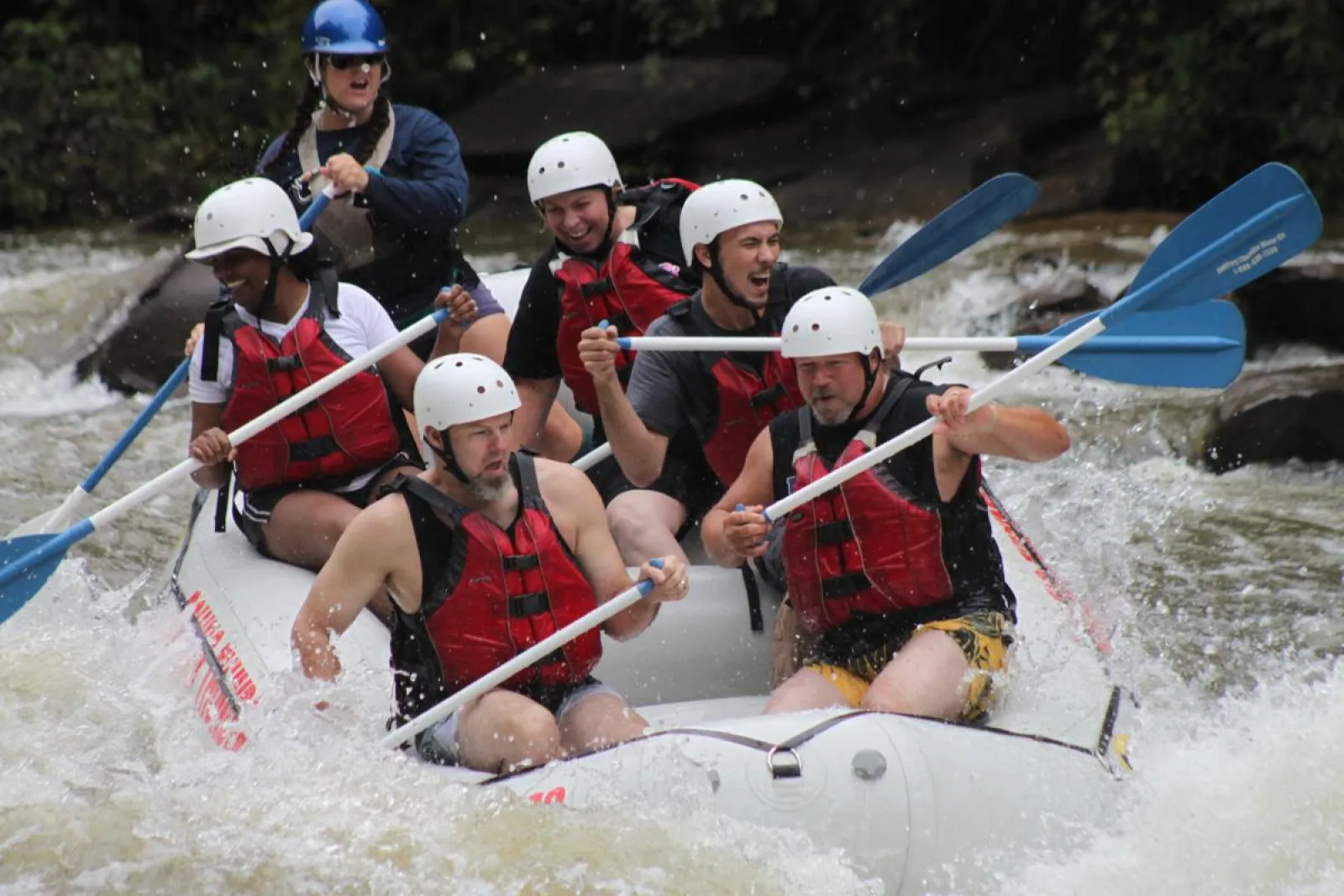 a group of people riding on the rapids