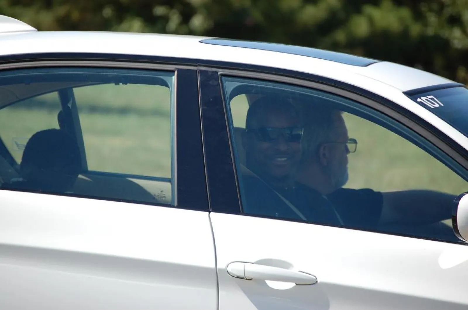 Eric in a car smiling at the camera