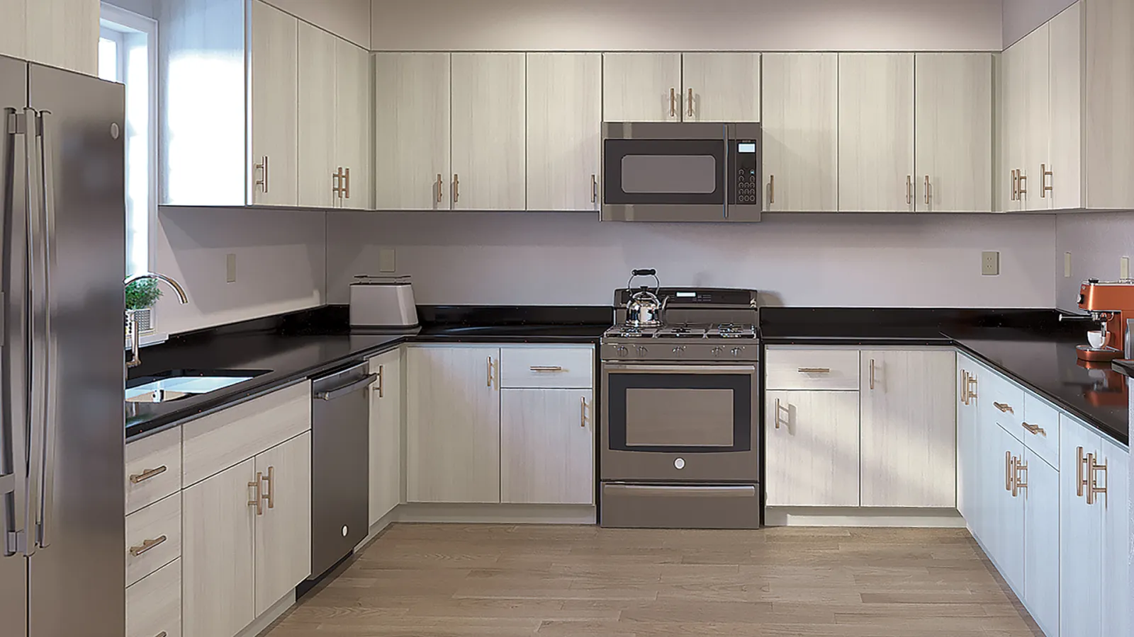 Modern kitchen with light wood cabinets, black countertops, stainless steel appliances, and hardwood floors