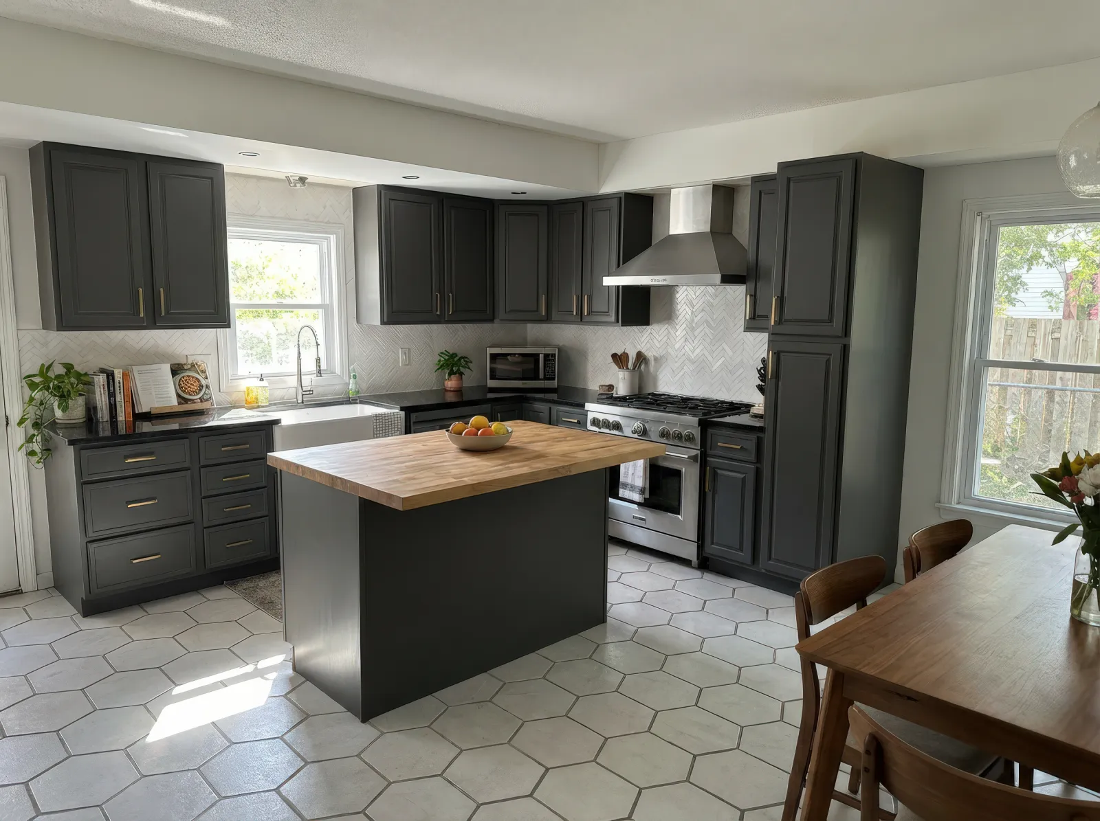 Modern kitchen with dark cabinets, wooden island countertop, stainless steel appliances, and hexagonal floor tiles