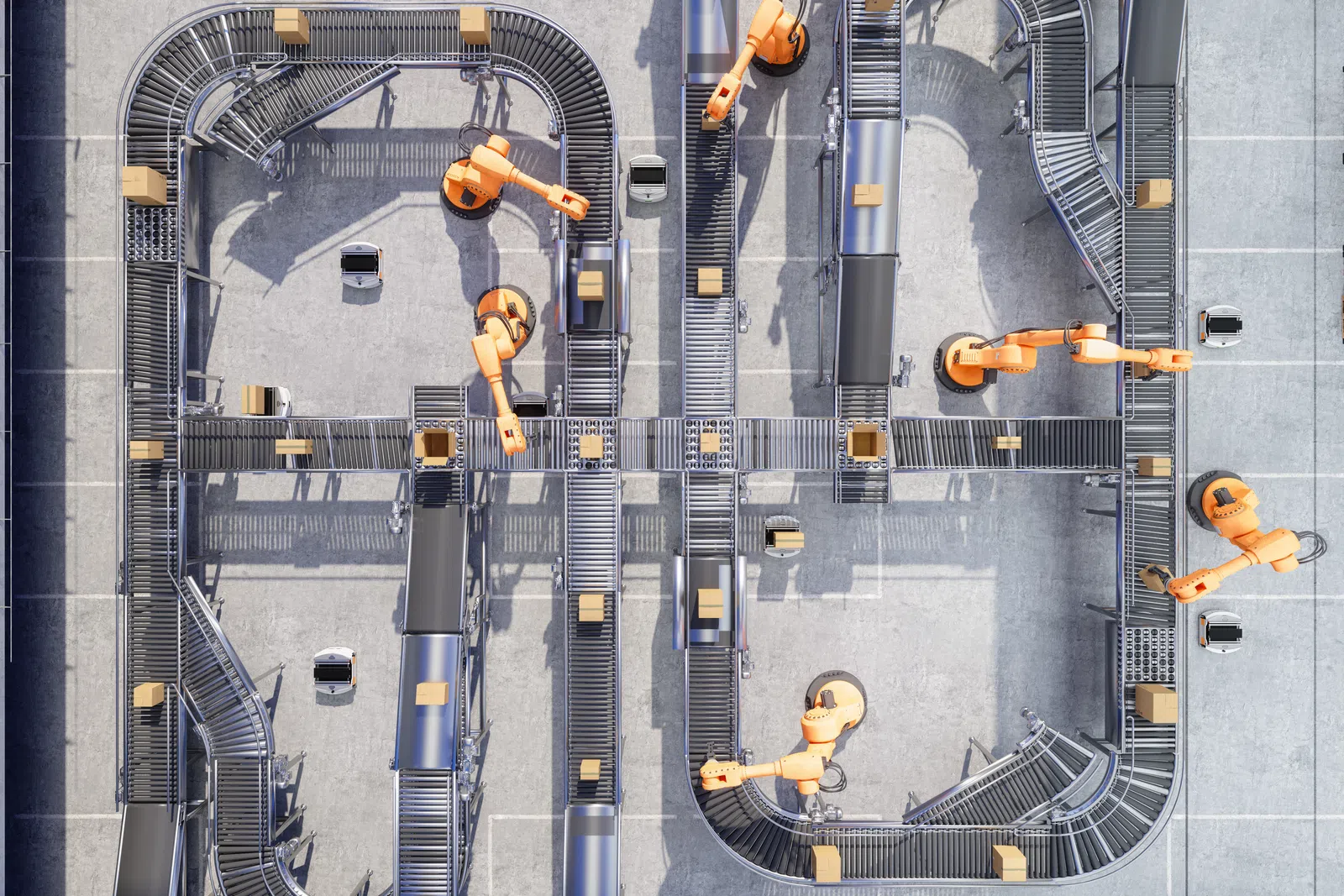 Top view of robotic arms sorting packages on conveyor belts in an automated warehouse system.