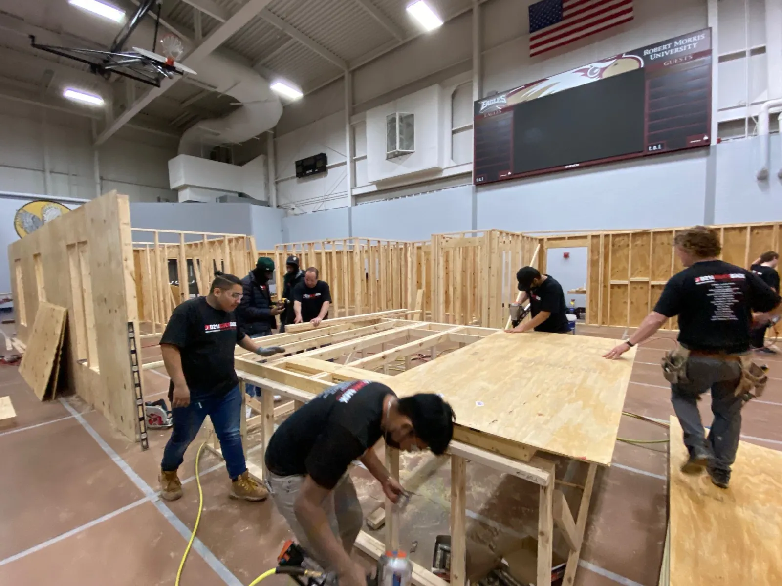 a group of people constructing tiny homes