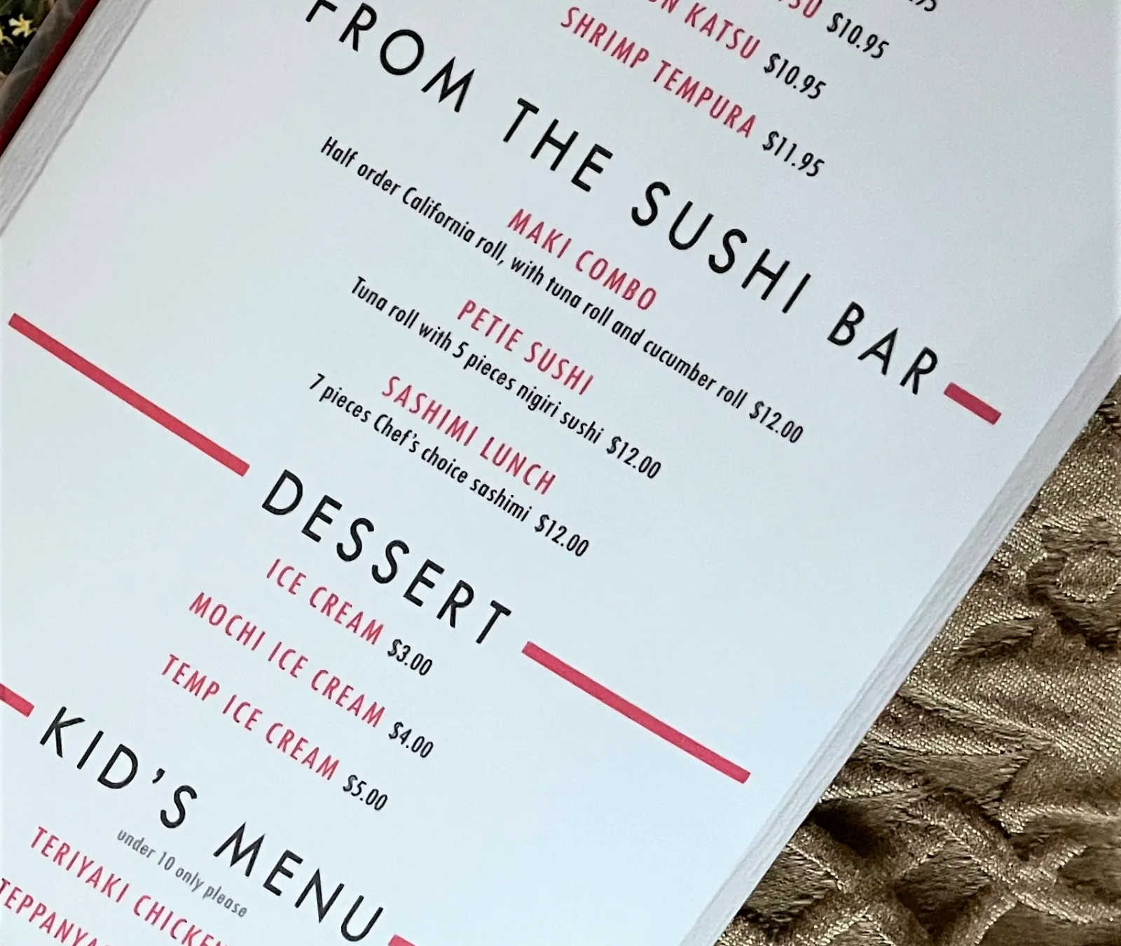 A laminate restaurant menu lying on a table