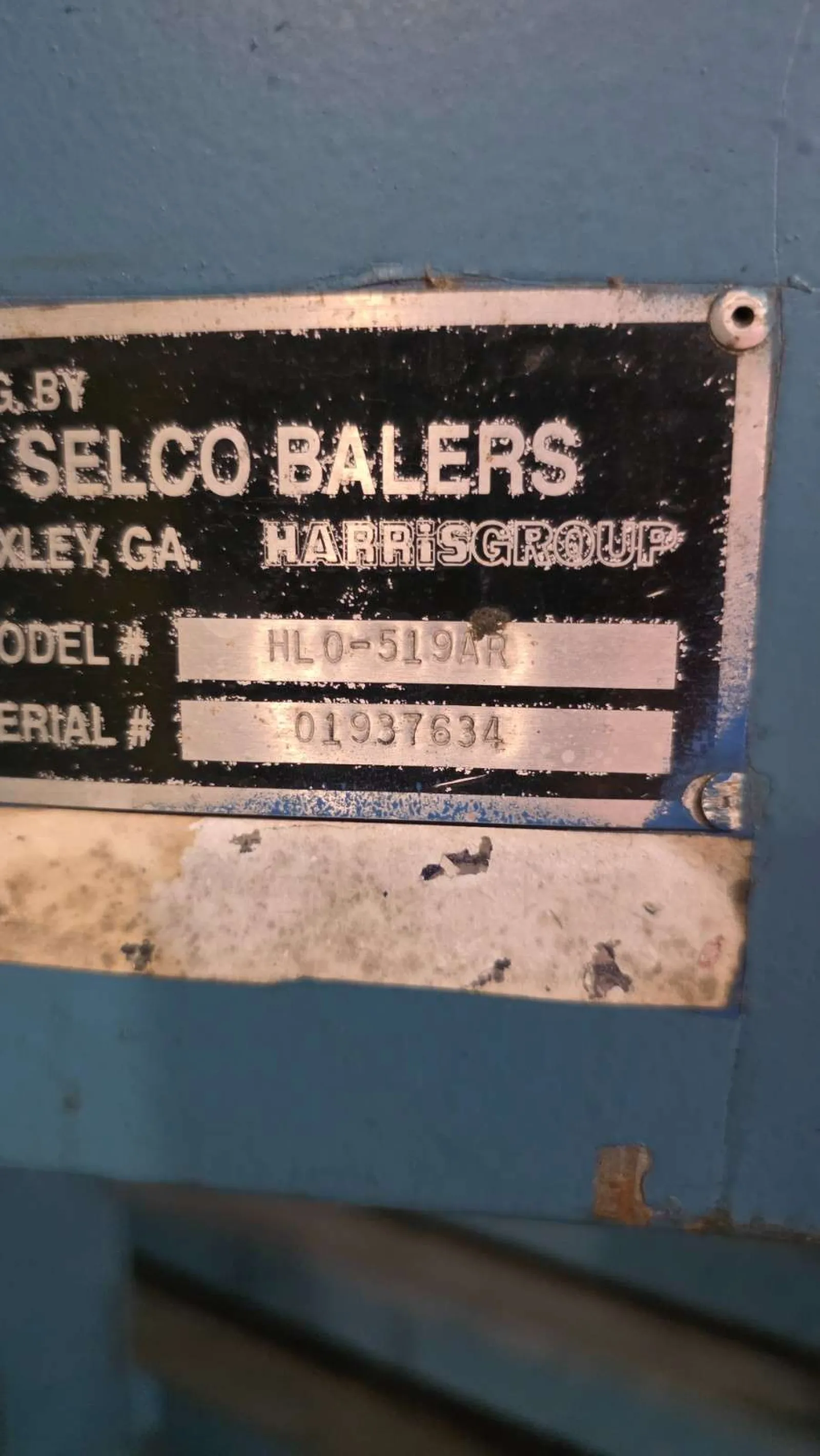 Close-up of Selco Balers metal identification plate with model HL0-519AR and serial number 01937634.