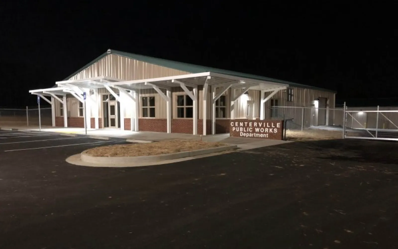 Night view of Centerville Public Works Department building with illuminated entrance and empty parking lot.