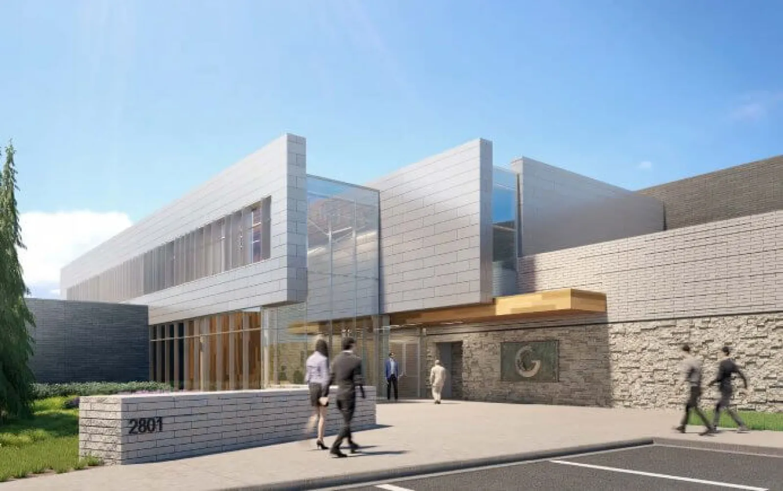 Modern commercial building with glass and stone facade and people walking outside in daytime under blue sky