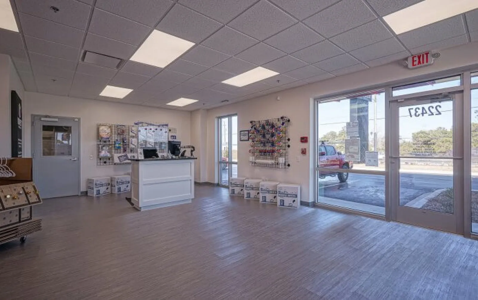 Bright, clean shipping store interior with counter, packing supplies, and large front windows showing outside view.
