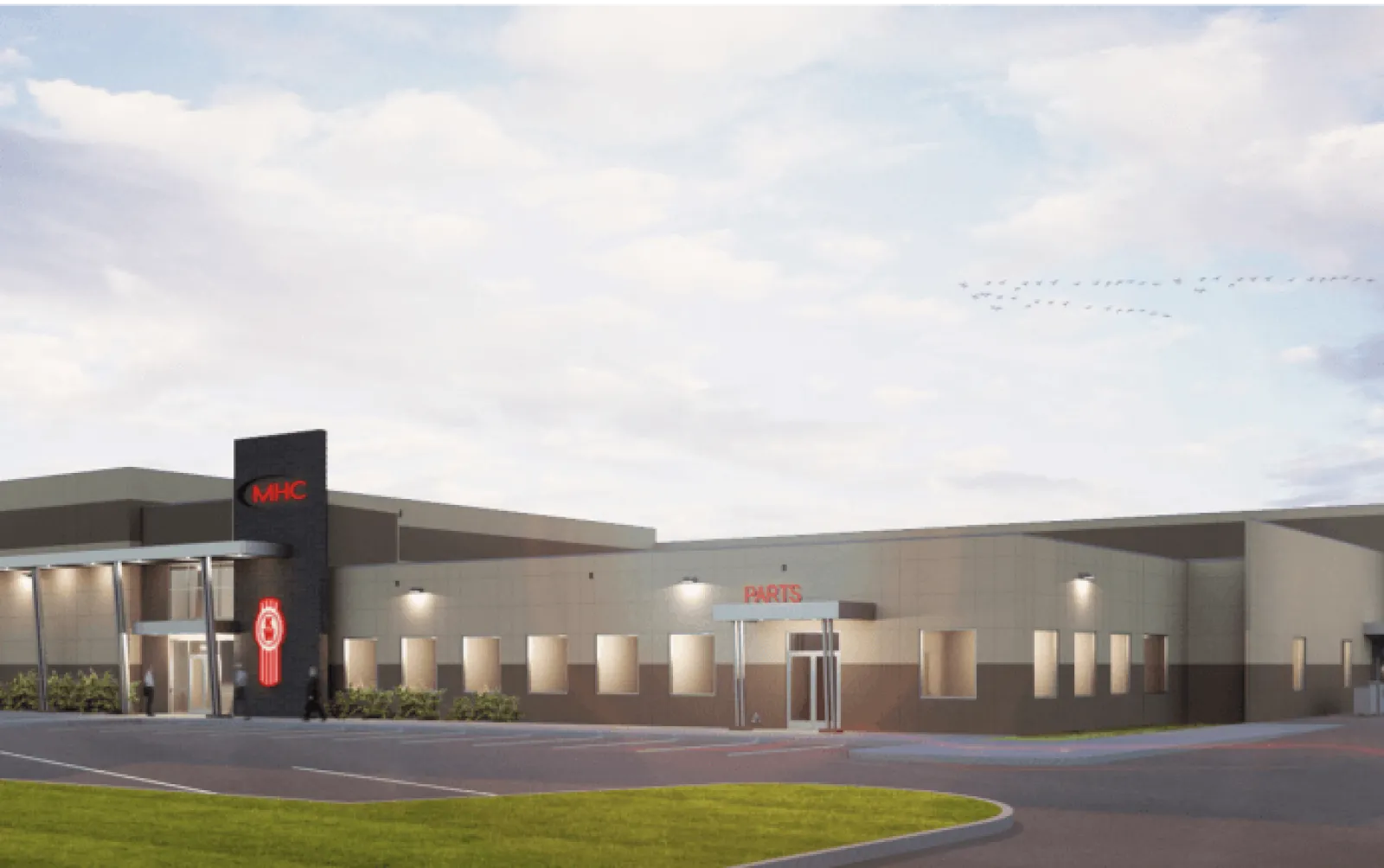 Modern industrial building with MHC logo and parts entrance under a cloudy sky with parked cars.