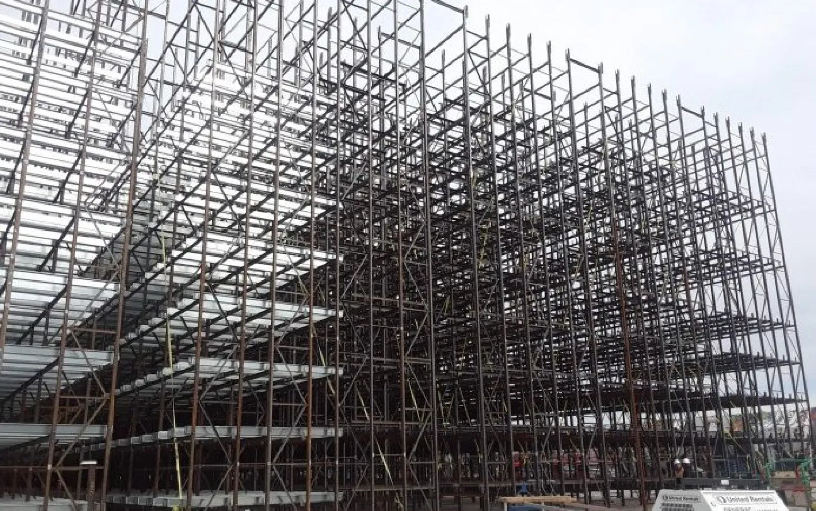 Extensive metal scaffolding structure assembled for construction with multiple interconnected levels and support beams.