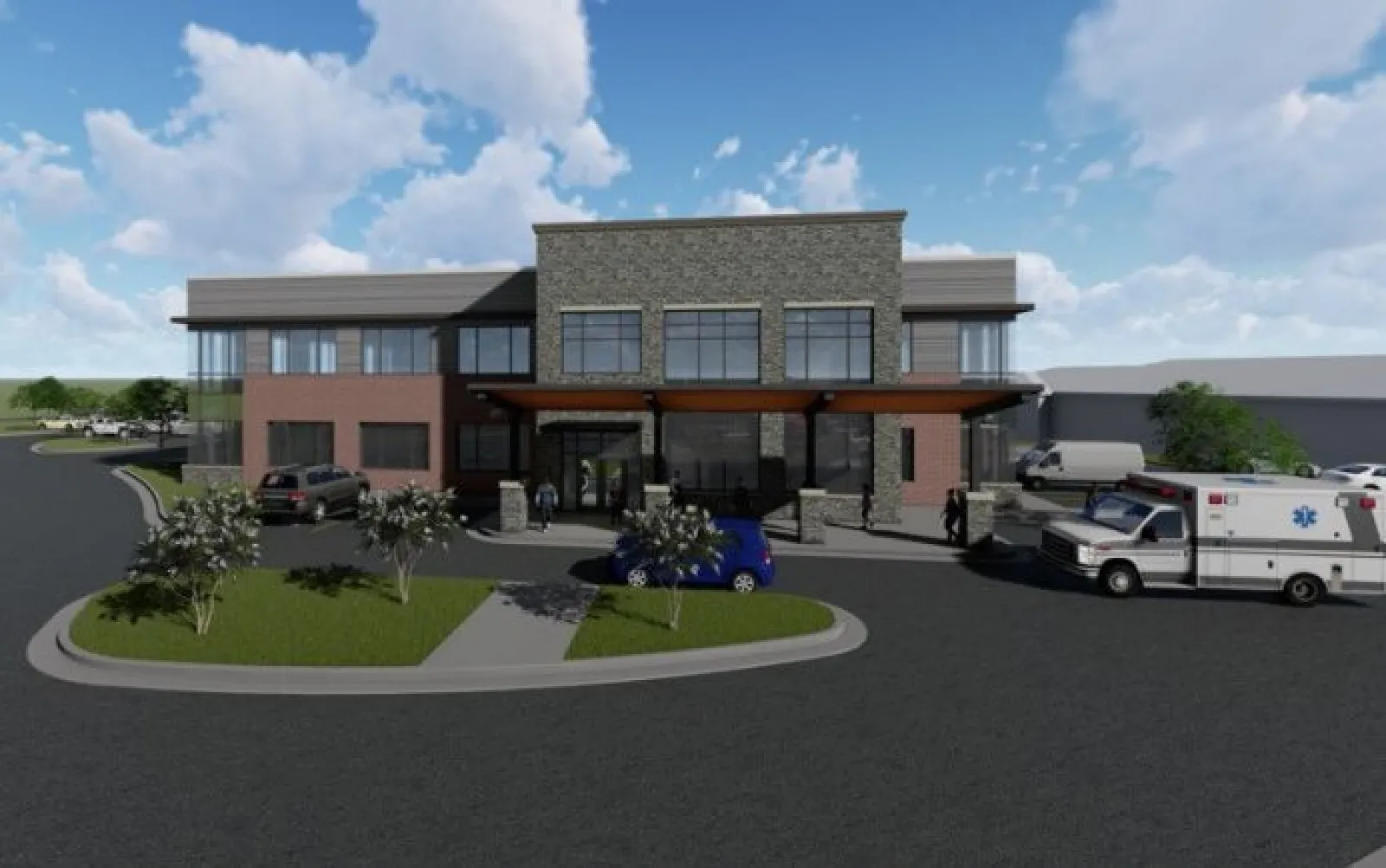 Modern two-story medical building with ambulance, parked cars, and landscaped entrance under blue sky with clouds