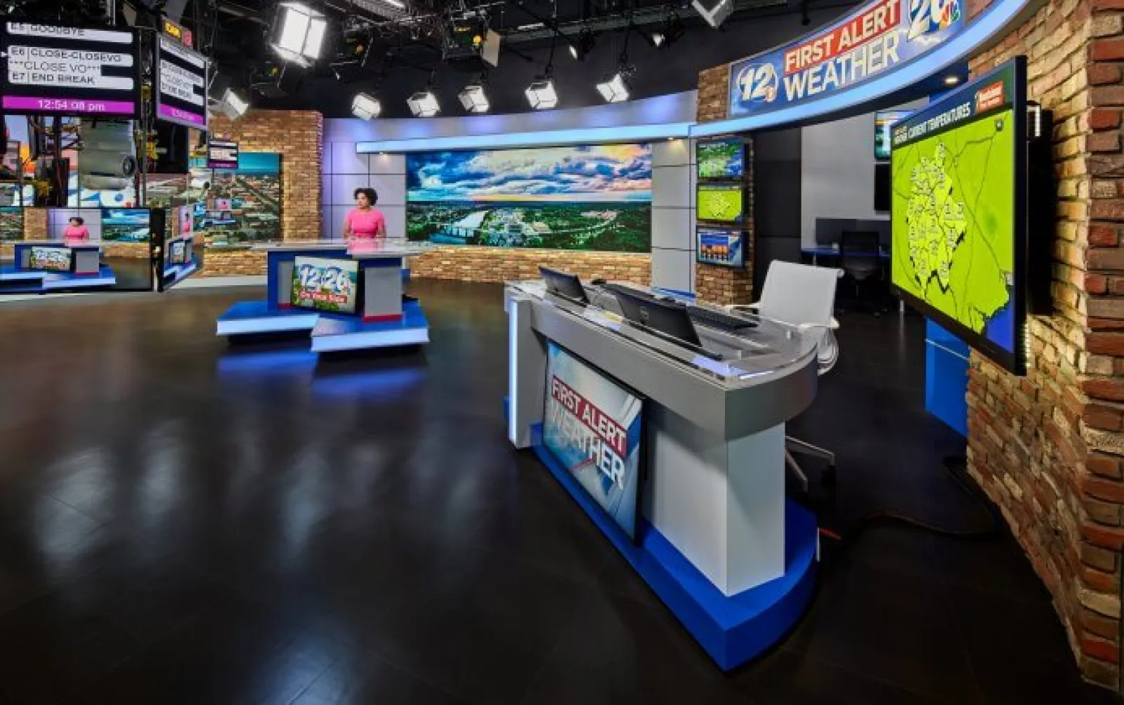 TV news weather studio with anchors, digital screens, and weather maps in a professional broadcast setting
