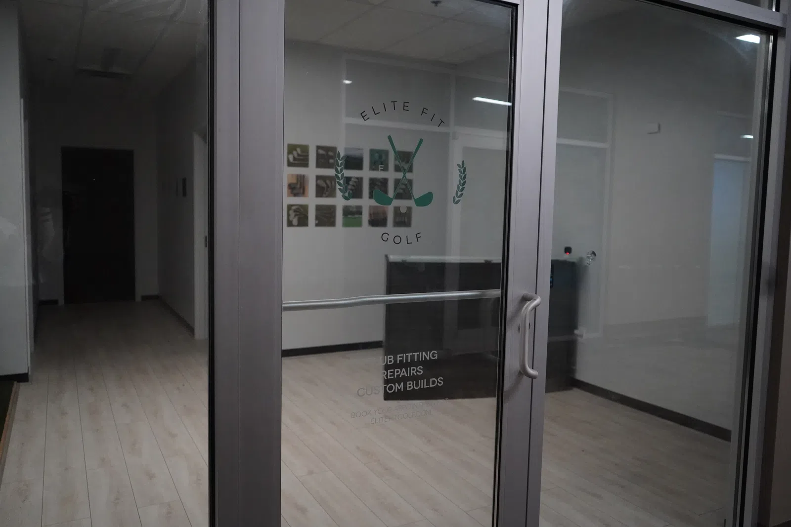 Glass entrance door to Elite Fit Golf featuring club fitting, repairs, and custom builds services inside.