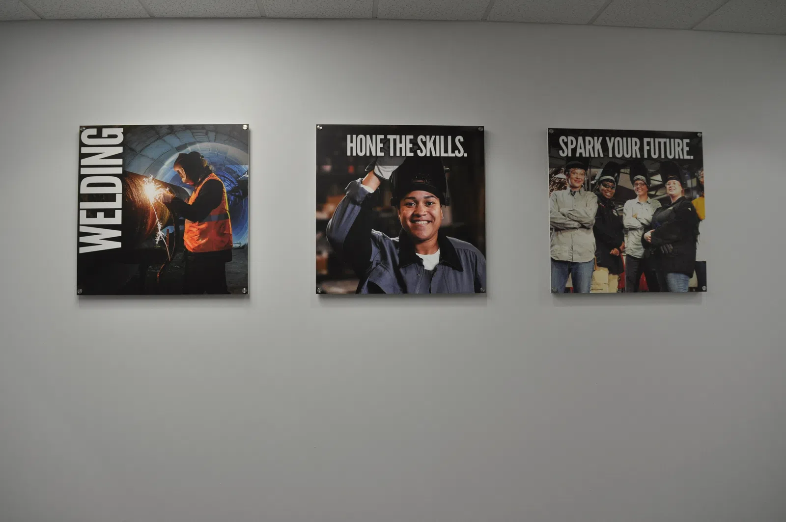 Three wall posters promoting welding skills and career growth in an industrial setting with workers in protective gear.