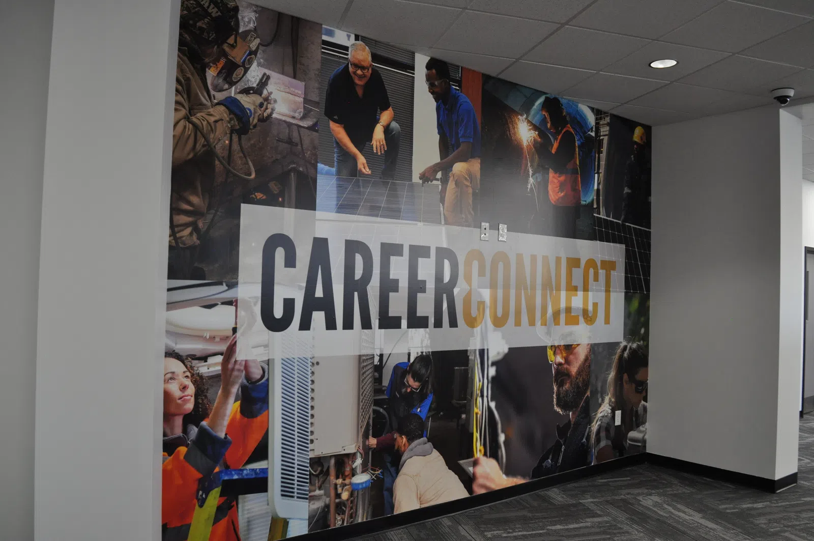 Wall mural with diverse workers in various trades surrounding the text Career Connect in a modern office.