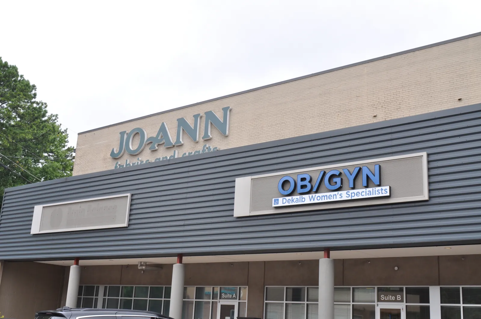 Exterior of a building with JO-ANN Fabrics and Crafts and OB/GYN Dekalb Women’s Specialists signs.