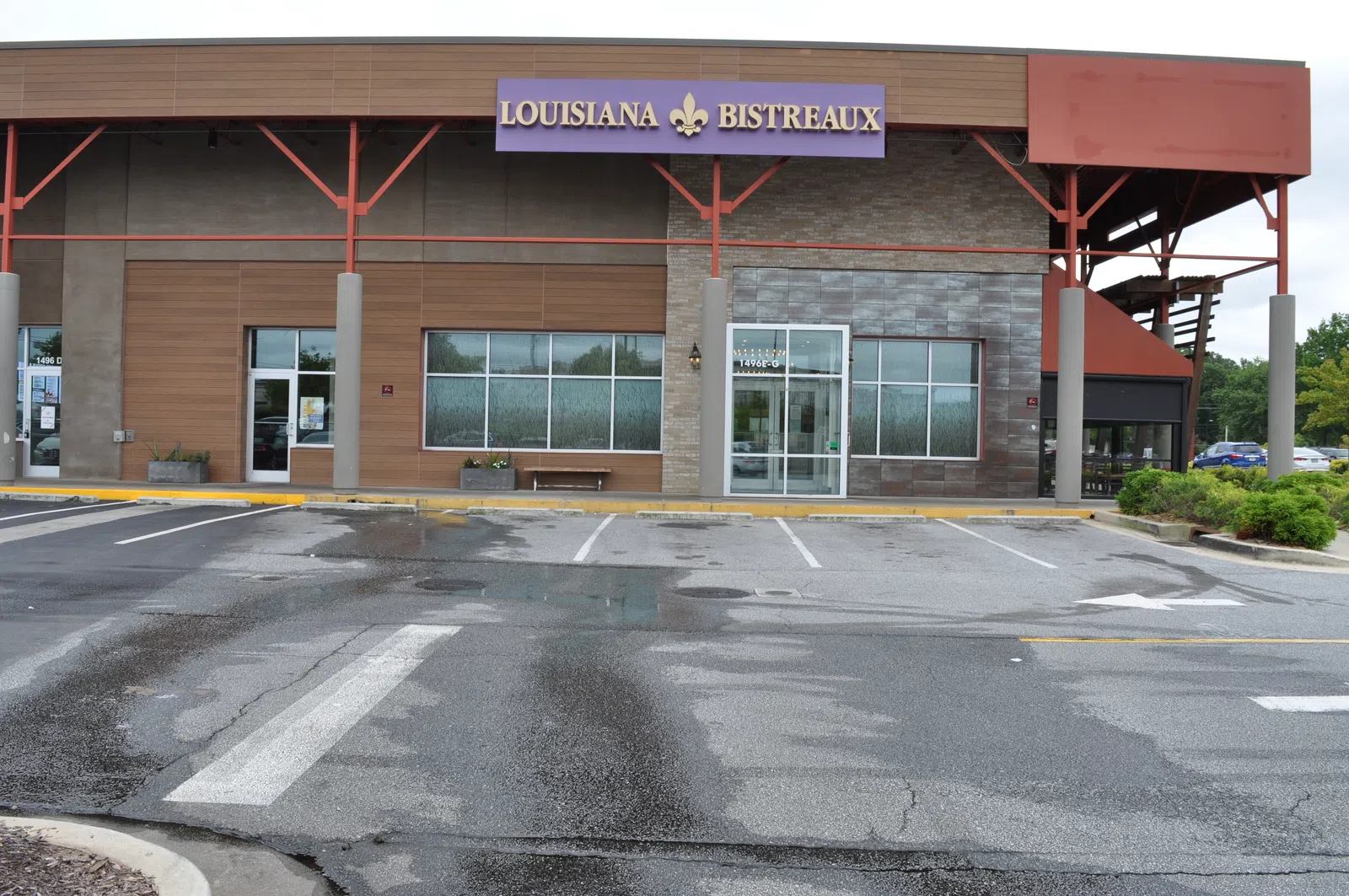 Exterior view of Louisiana Bistreaux restaurant with empty parking lot on a cloudy day.