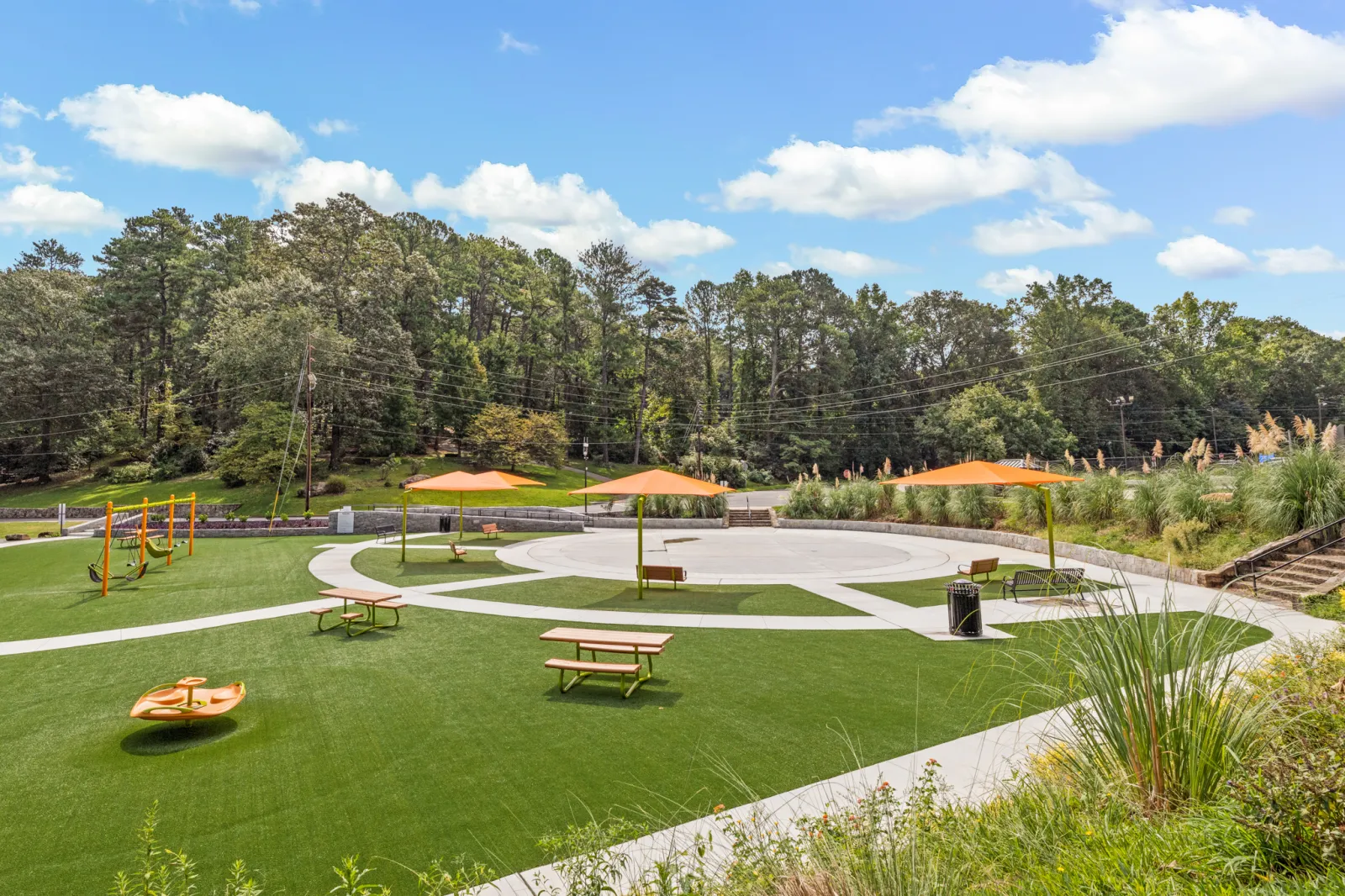 a park with benches and umbrellas