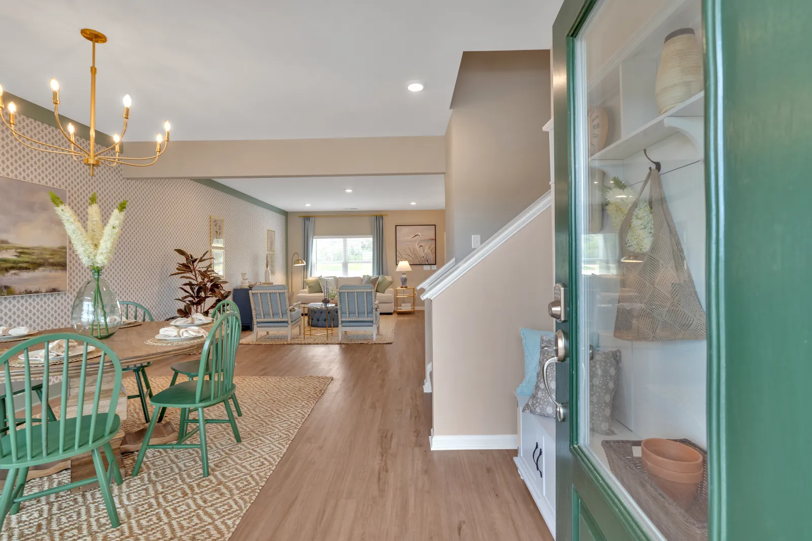 Welcoming interior view of a modern dining area with green chairs and stylish decor elements.