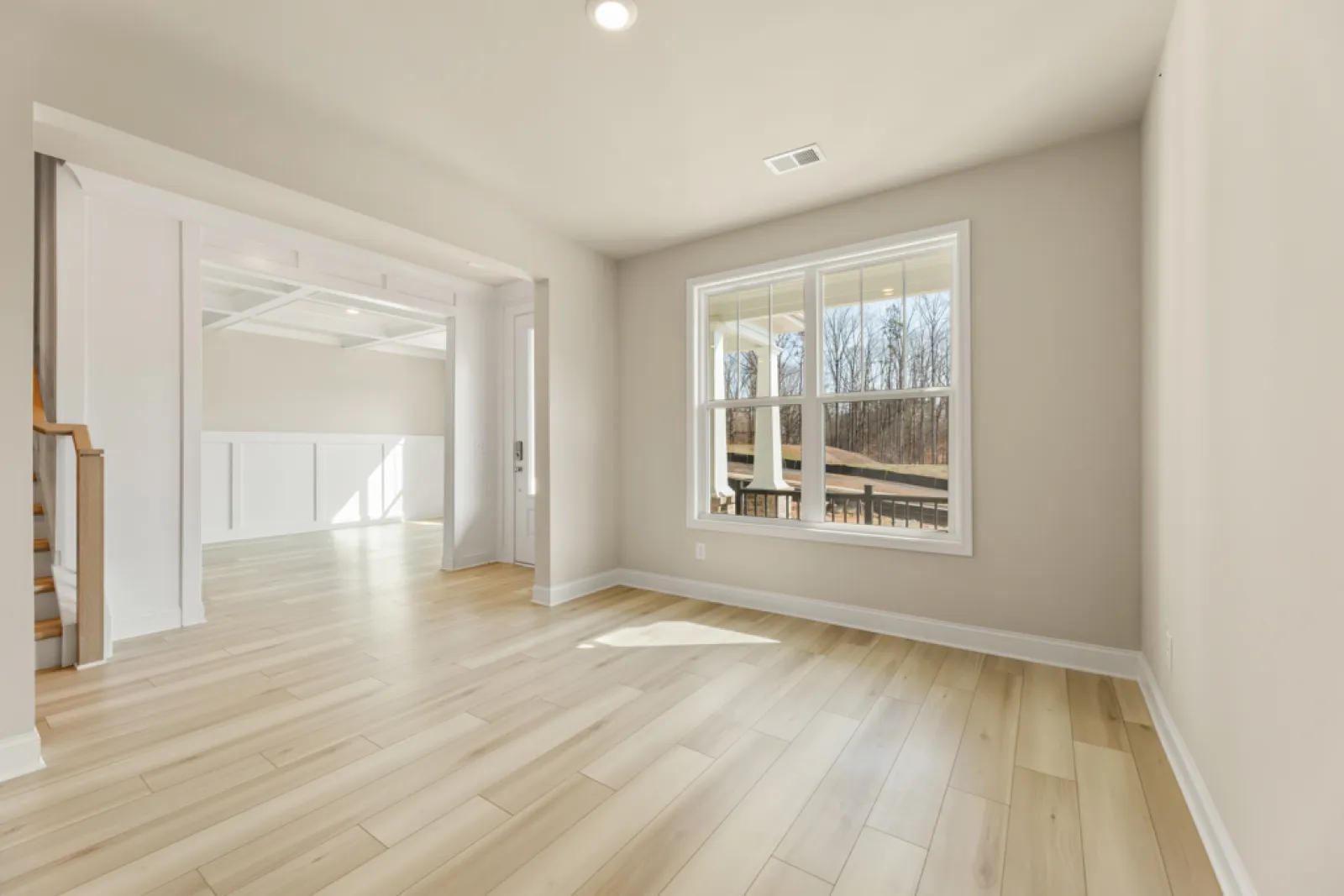 a room with a wood floor and a window