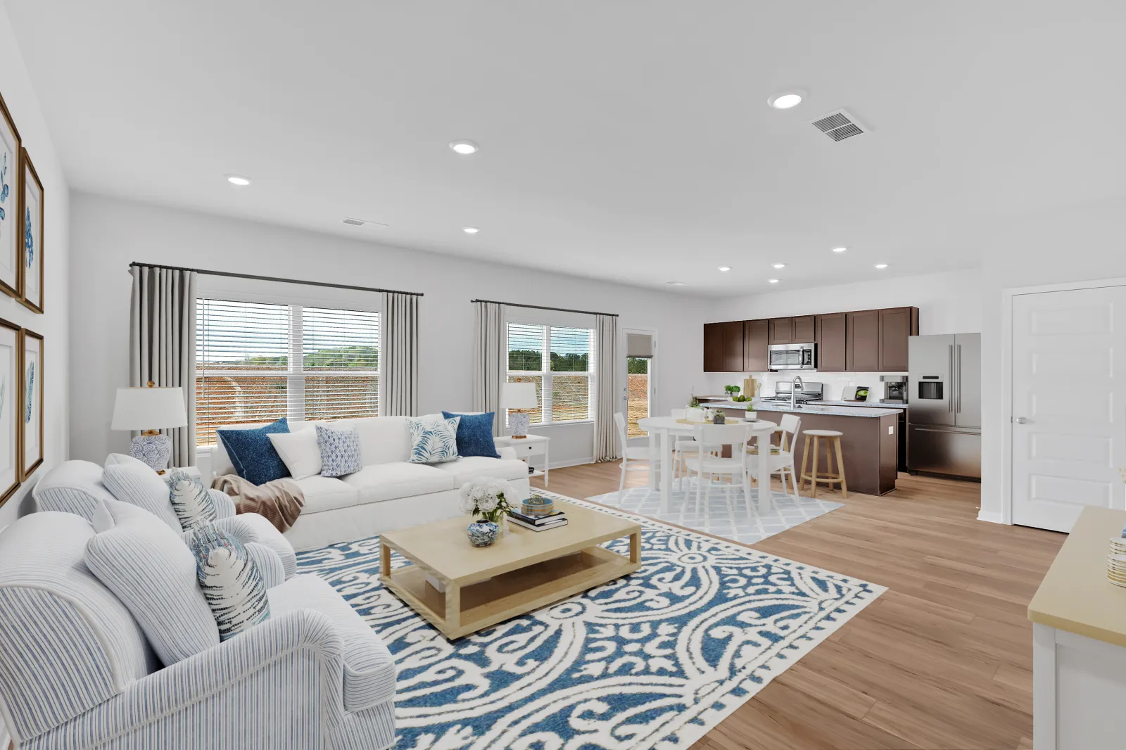 Bright and modern living room with comfortable seating and stylish decor, featuring a cozy dining area.