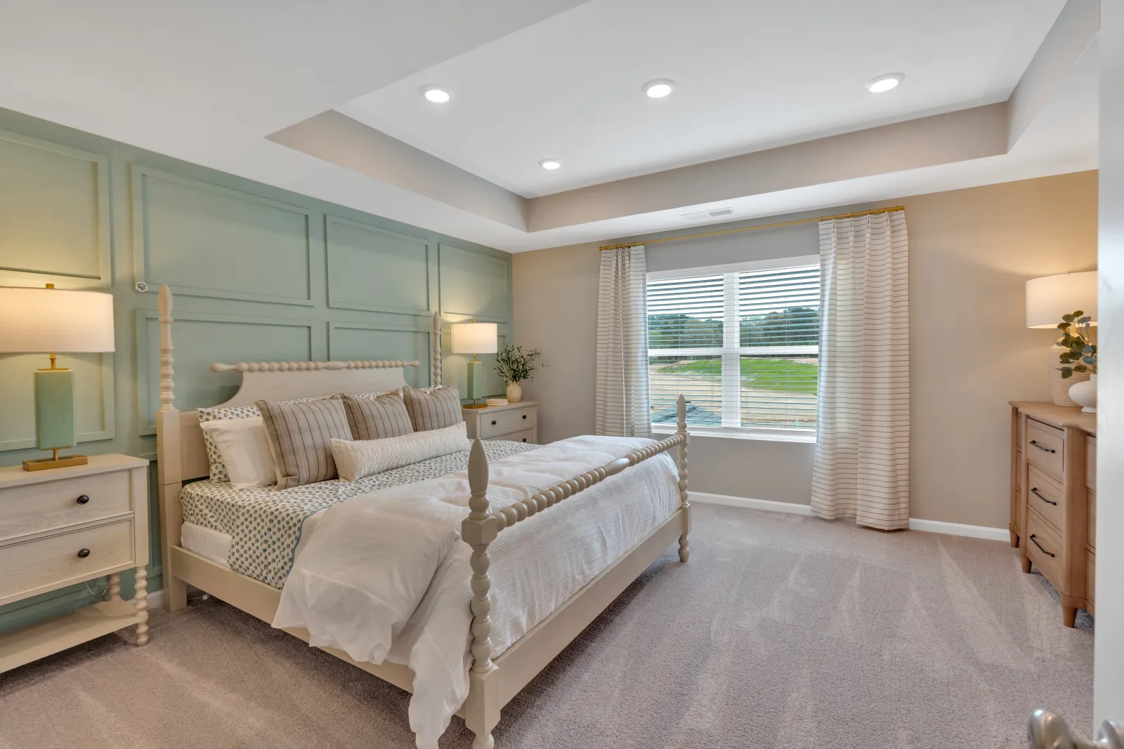 Modern bedroom with light colors, stylish furniture, and ample natural light from the window.