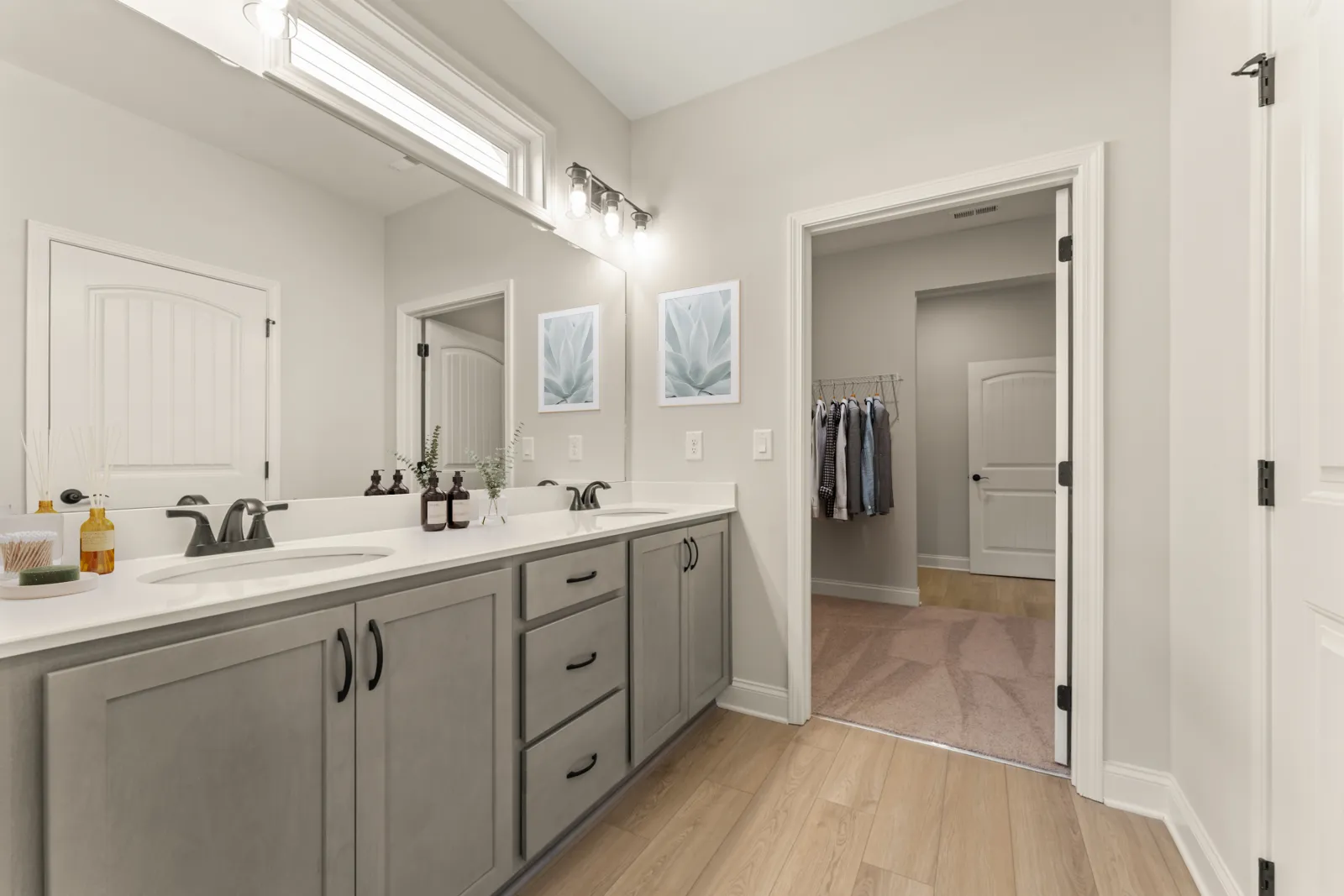 a bathroom with white cabinets