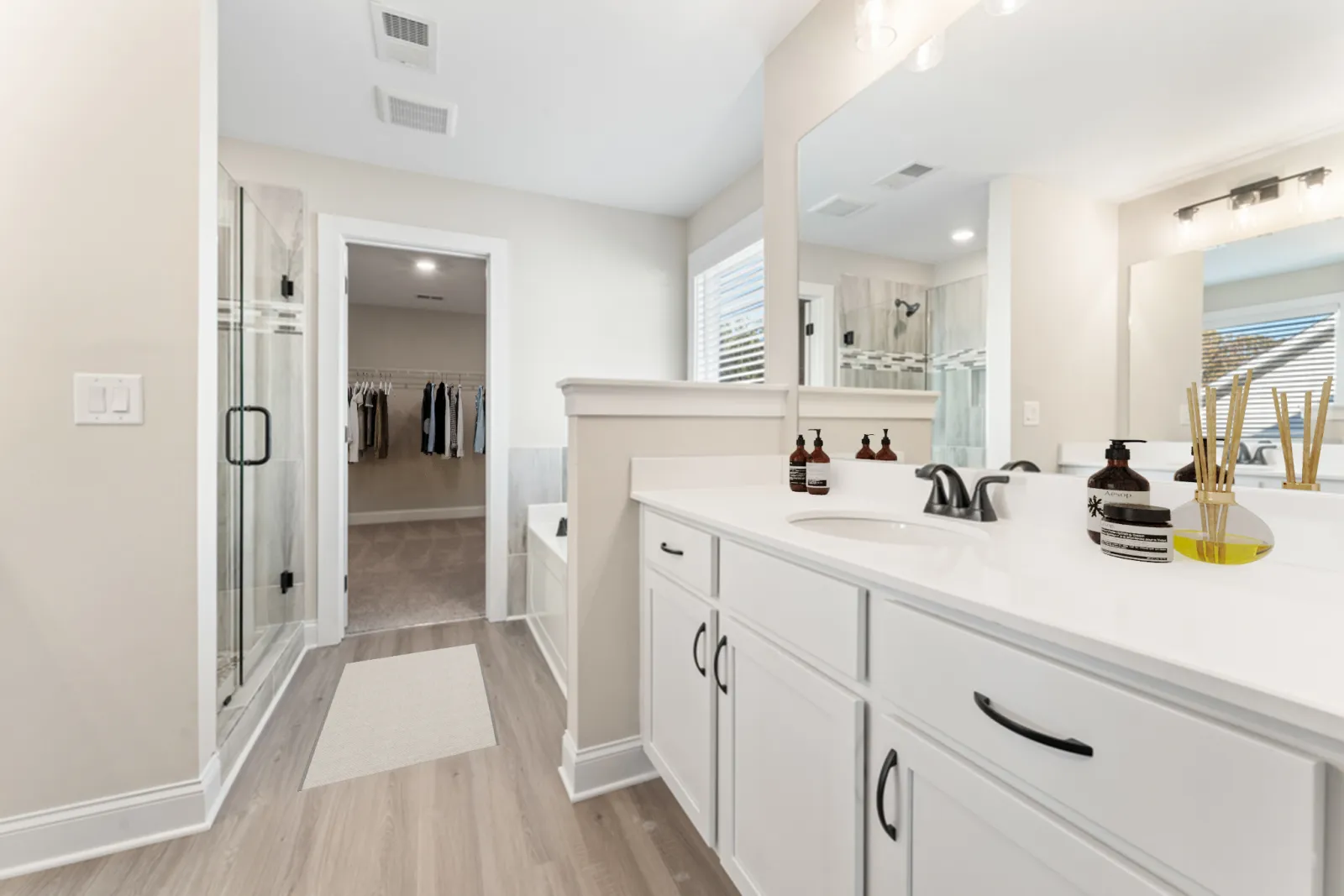 a bathroom with white cabinets