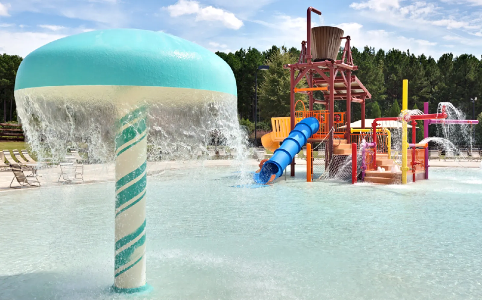 Water park splash pad with large mushroom fountain and colorful play structures under blue sky.