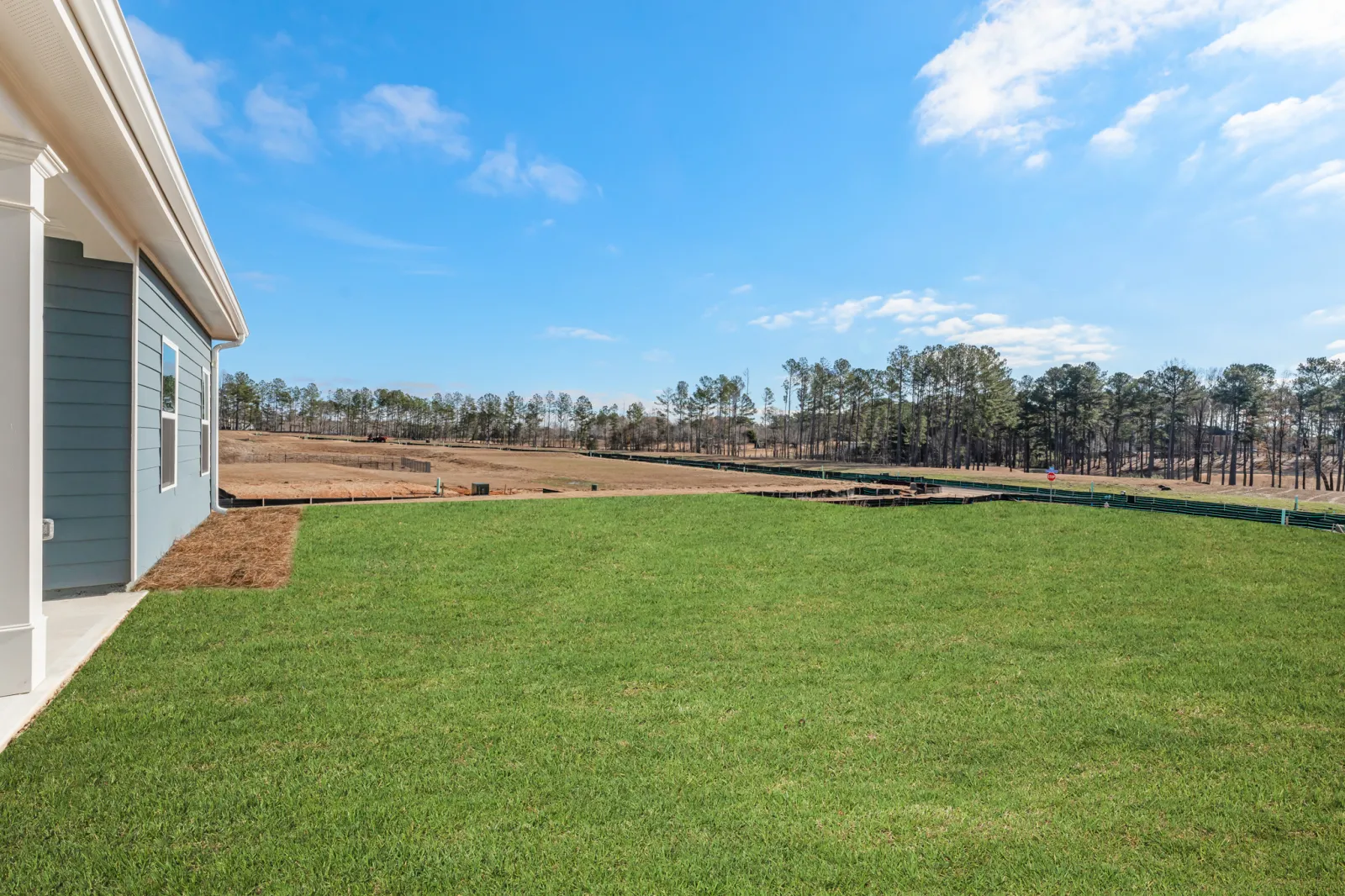 a large green lawn next to a building