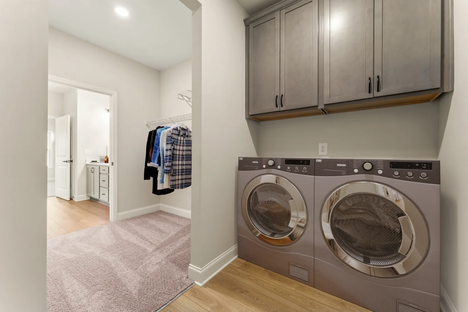 a room with a washing machine and a rug