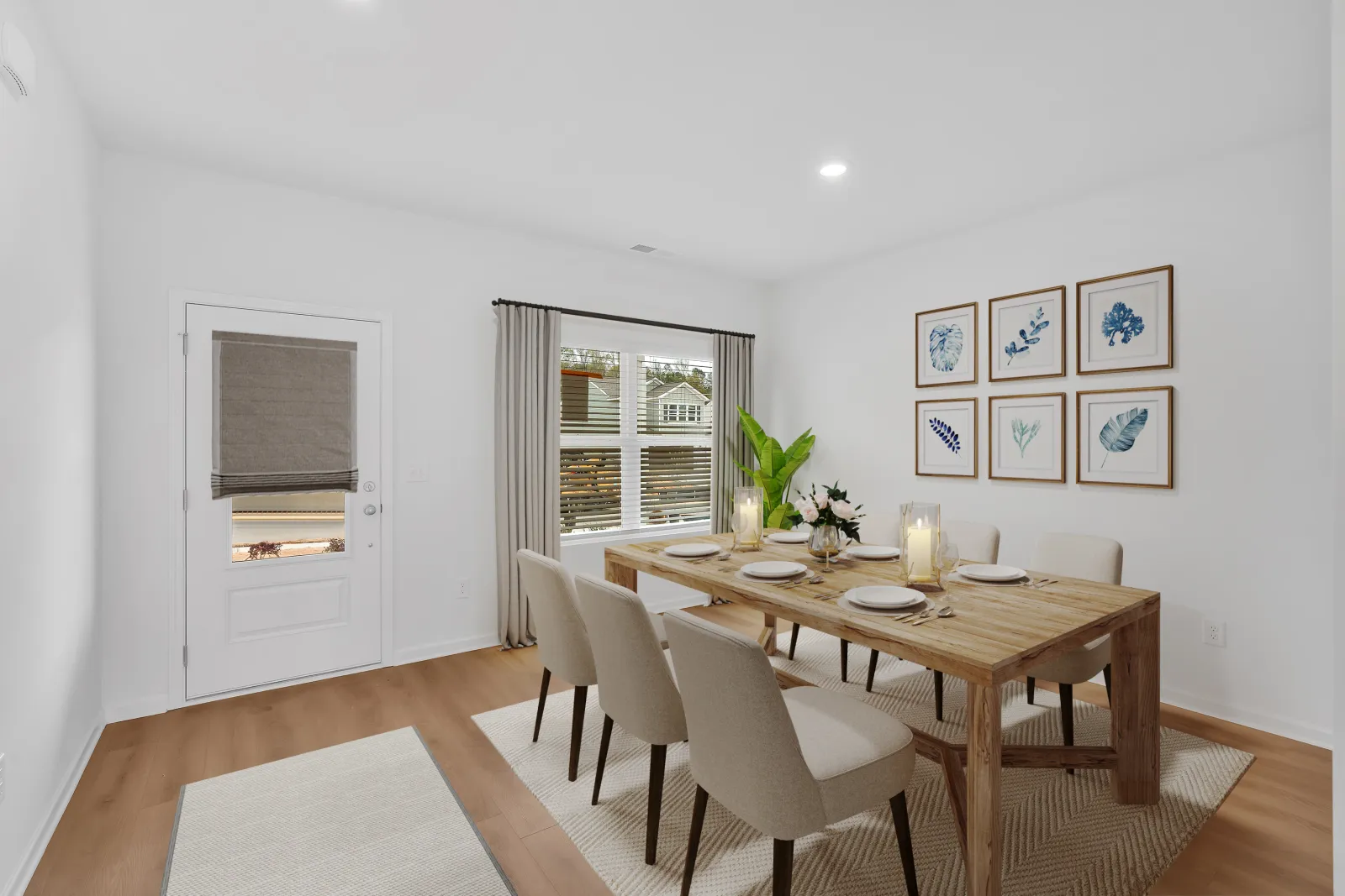 Bright modern dining room with wooden table, six beige chairs, wall art, and natural light from window.