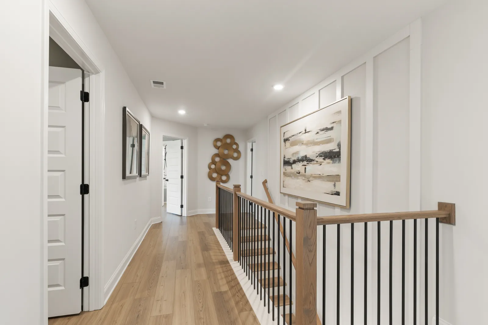 a hallway with a wood railing