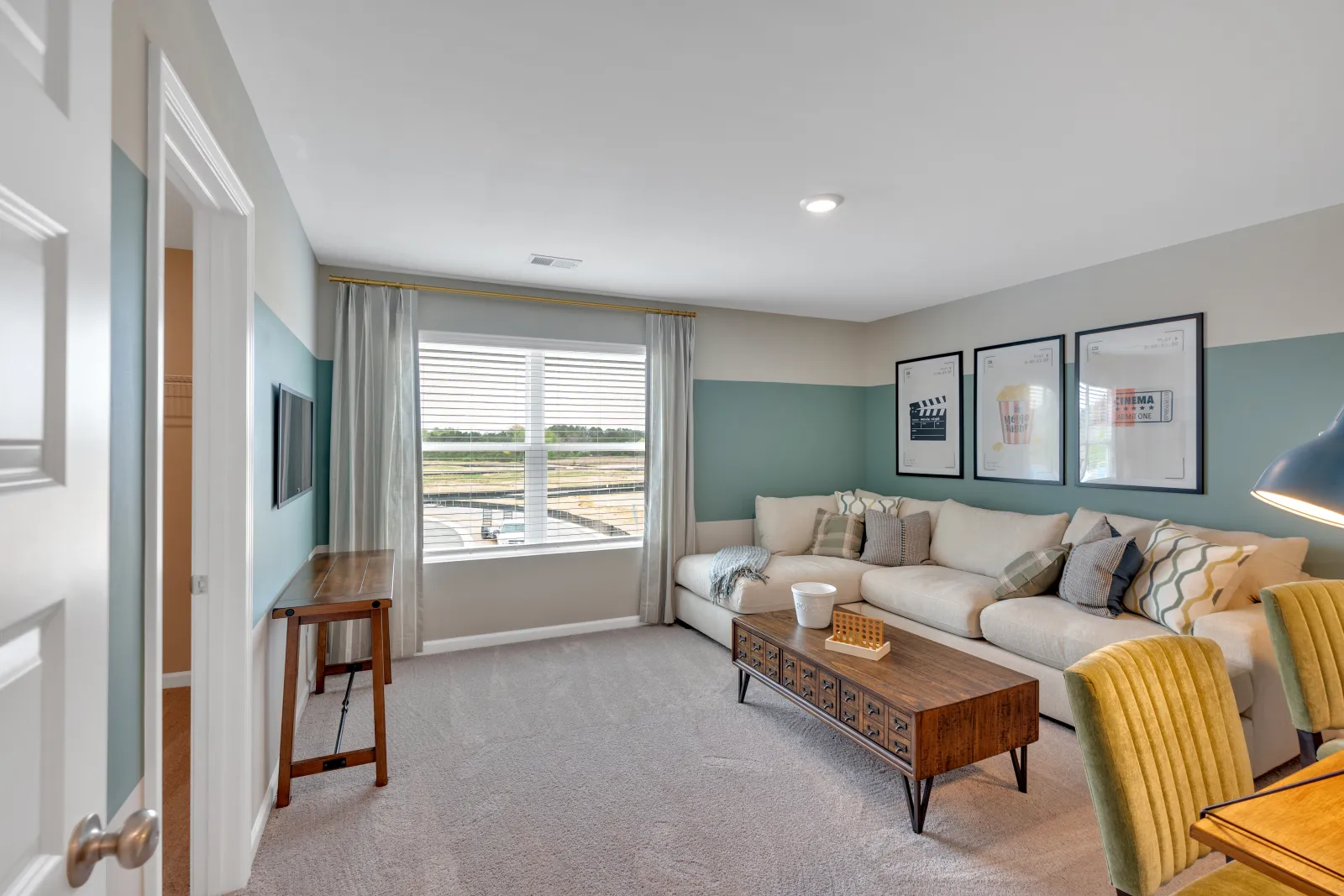Stylish living room with a cozy sofa, modern decor, and large window letting in natural light.