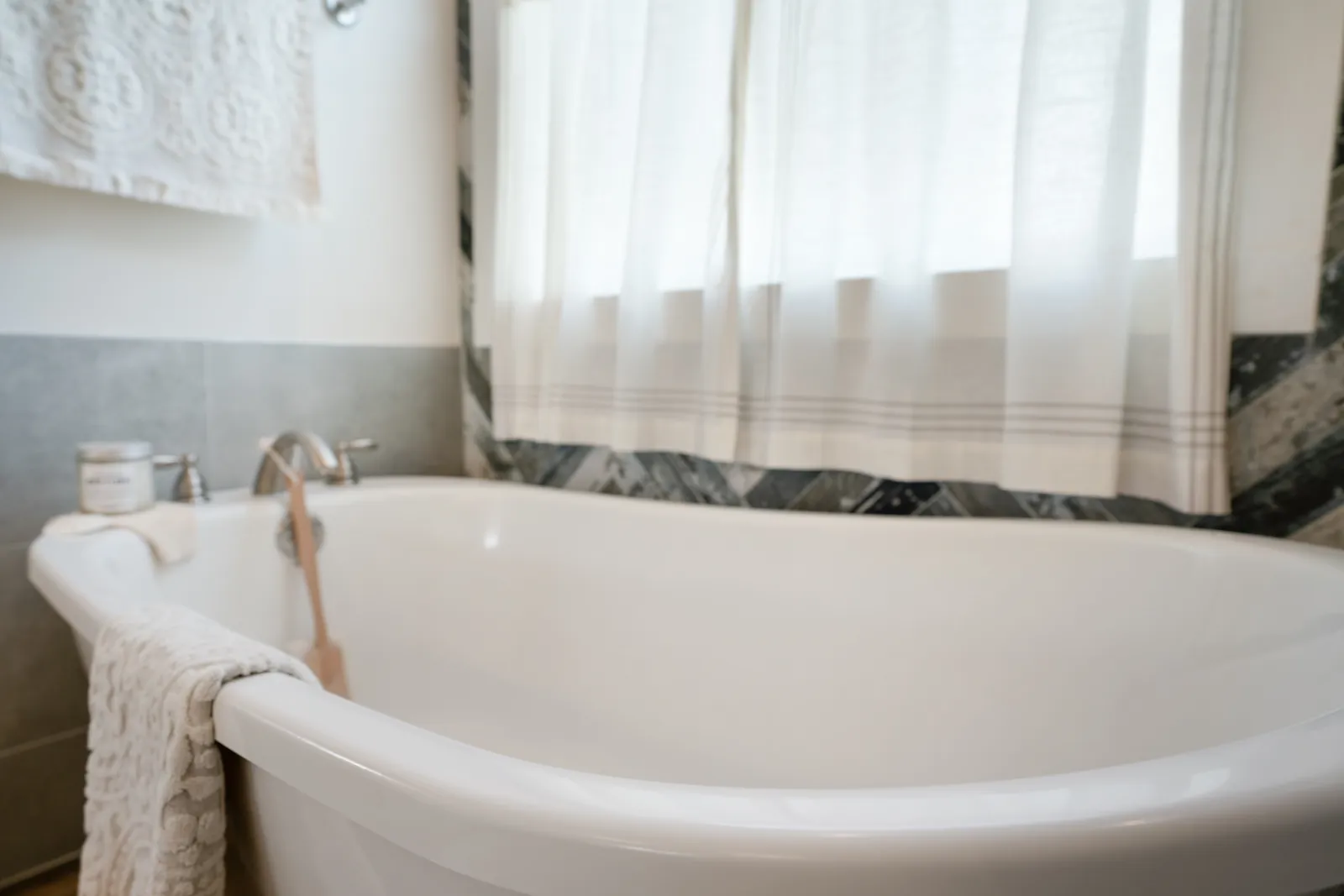 a bathtub with a towel from the side