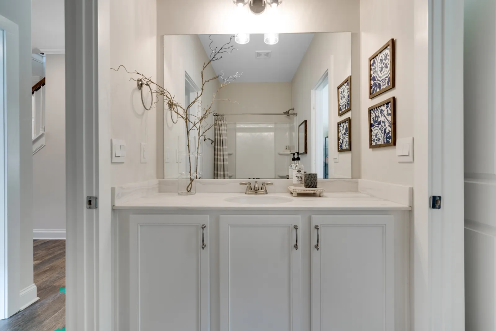 a bathroom with white cabinets