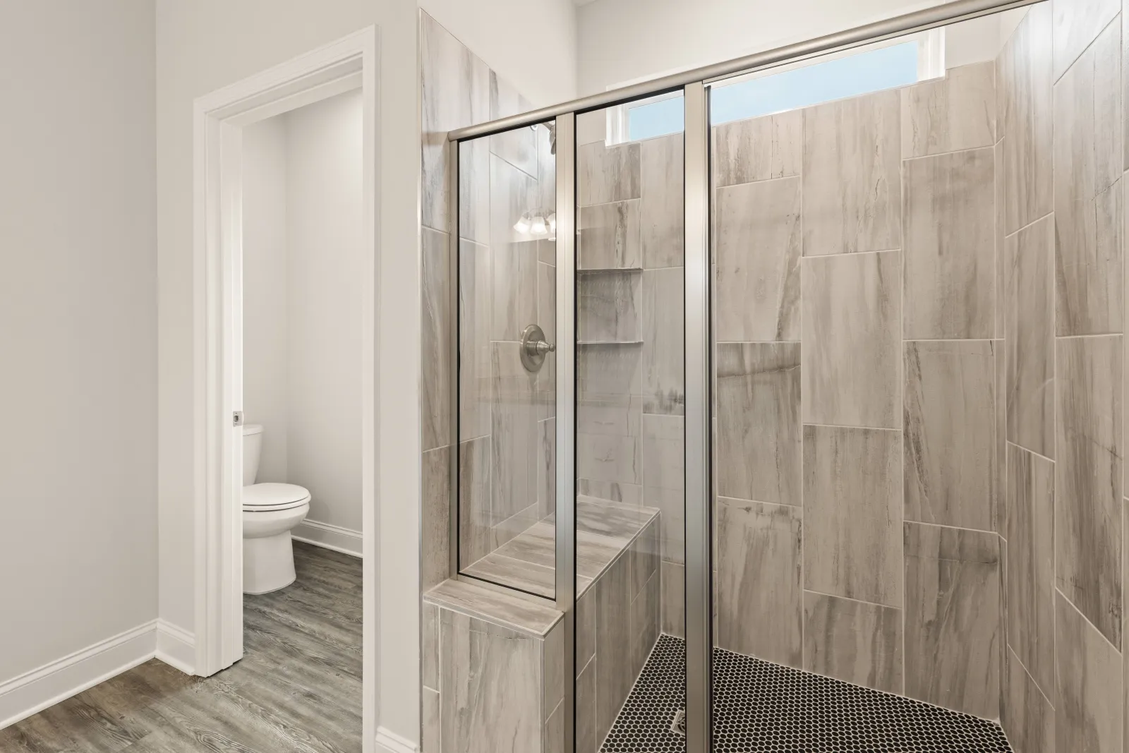 Tiled shower with built-in bench & glass door