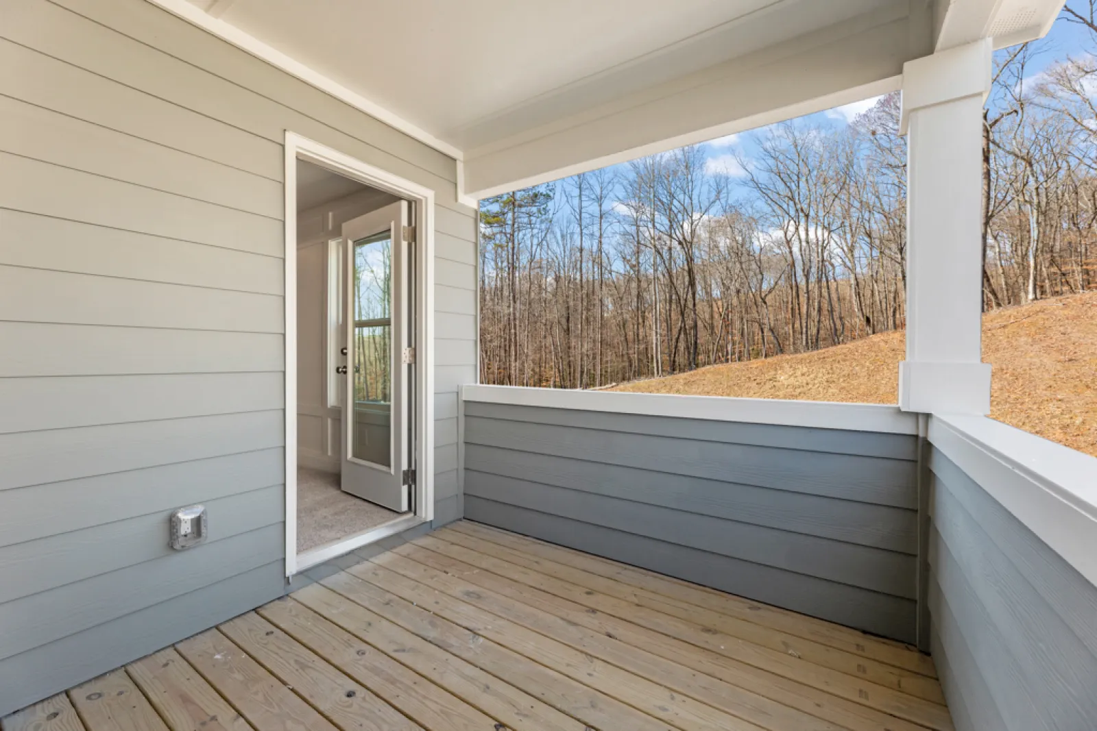 a white building with a wood deck