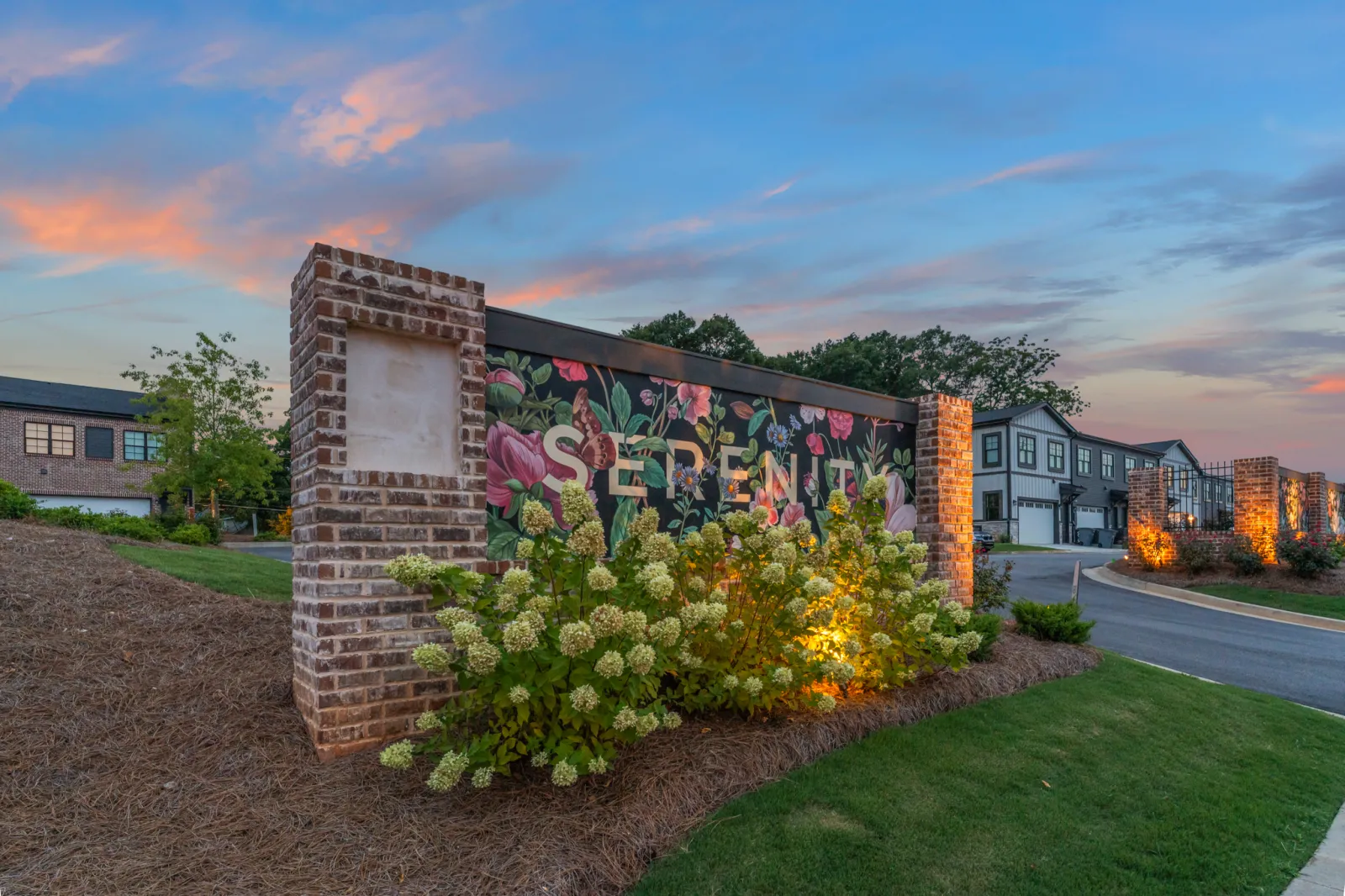 a wall with flowers and a sign