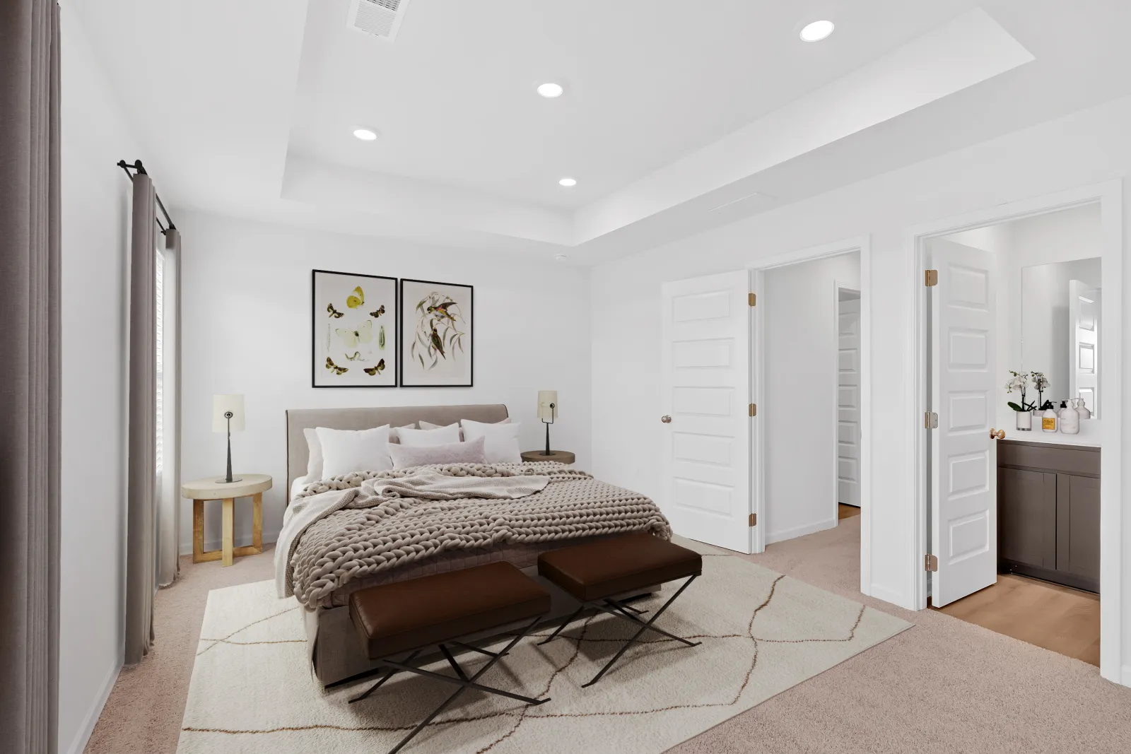 Bright modern bedroom with neutral tones, king bed, decorative pillows, bench, and artwork above the headboard