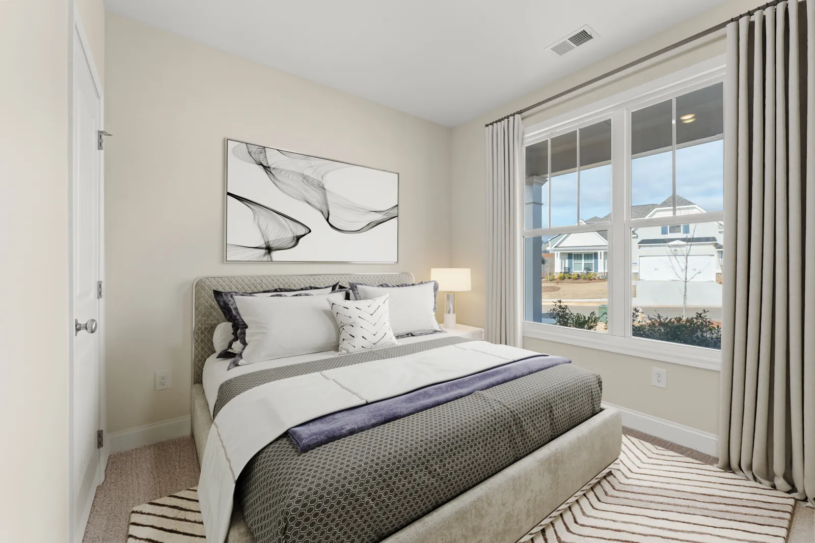 a bedroom with a large window