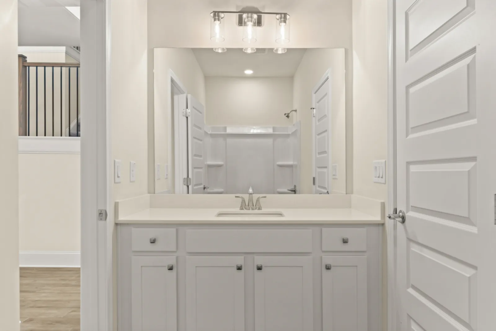 a bathroom with white cabinets