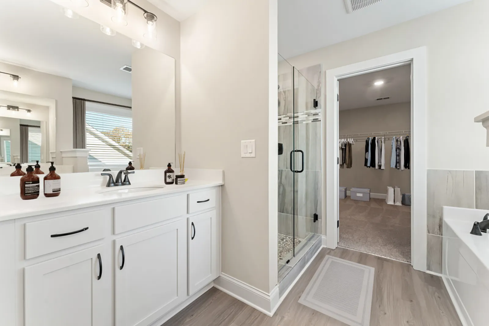 a bathroom with a shower unit and a sink