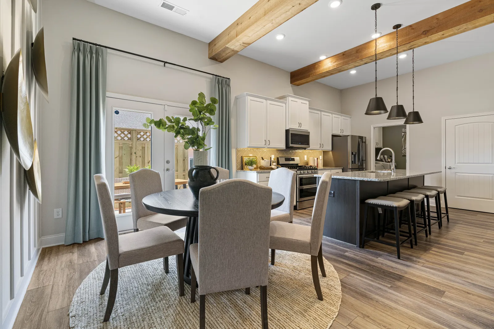 a kitchen with a dining table and chairs