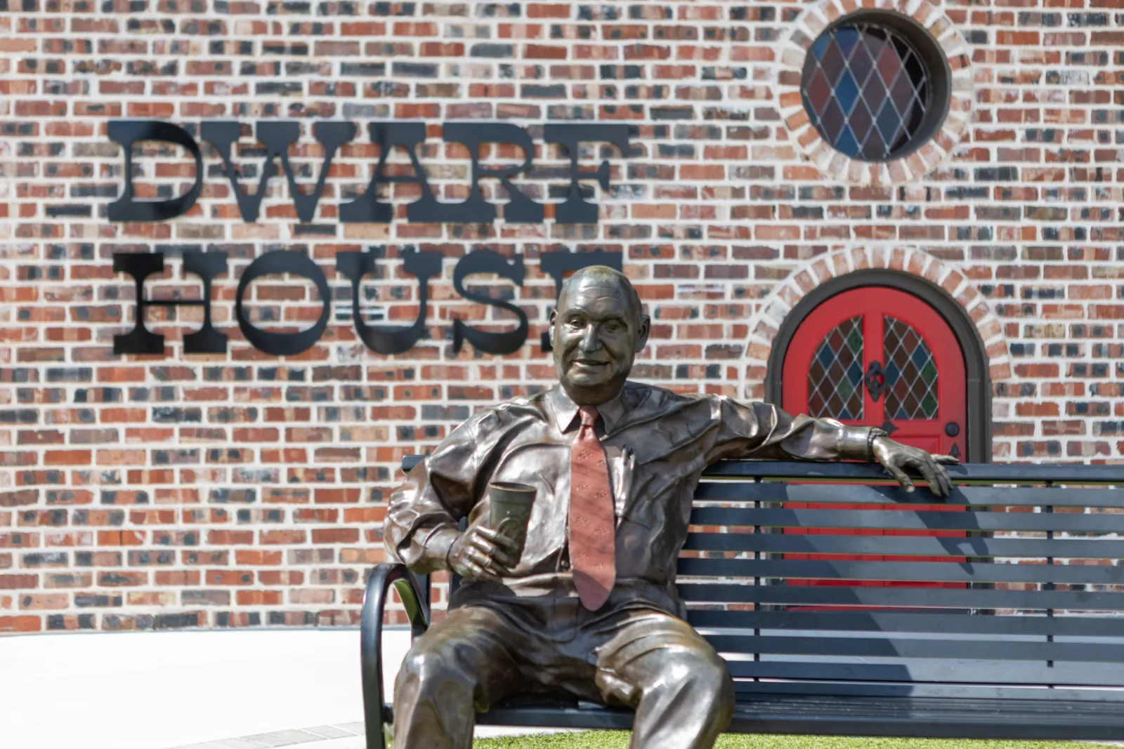 a statue of a man sitting on a bench