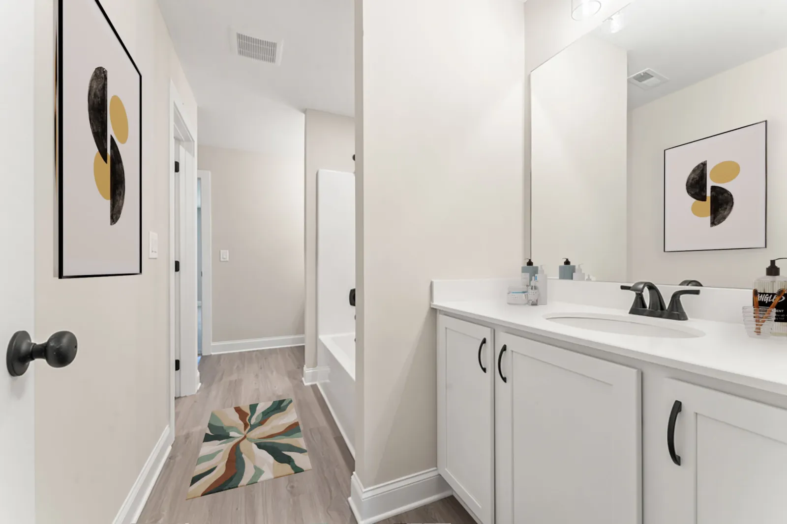 a bathroom with white cabinets