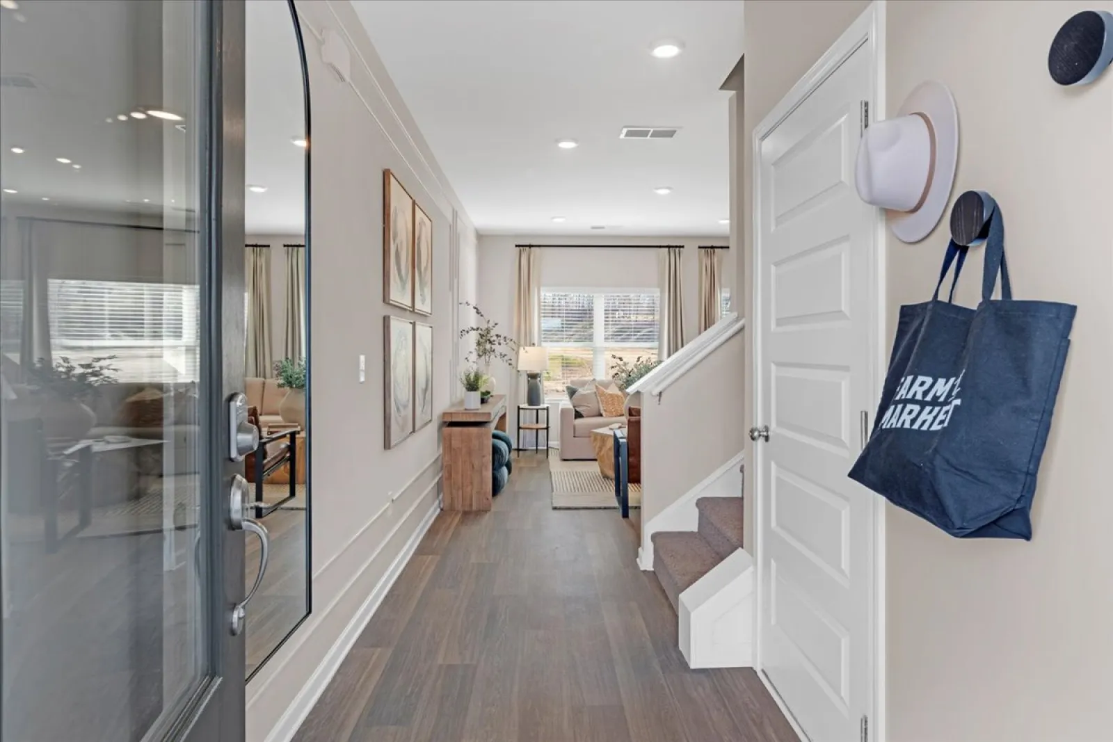 Bright and spacious entryway with a cozy living room and stylish decor elements.