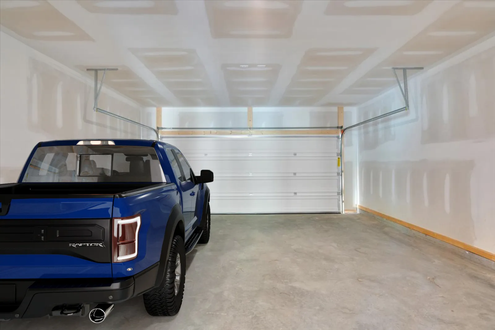 Blue pickup truck parked inside an empty, unfinished white garage with concrete floor and closed door.