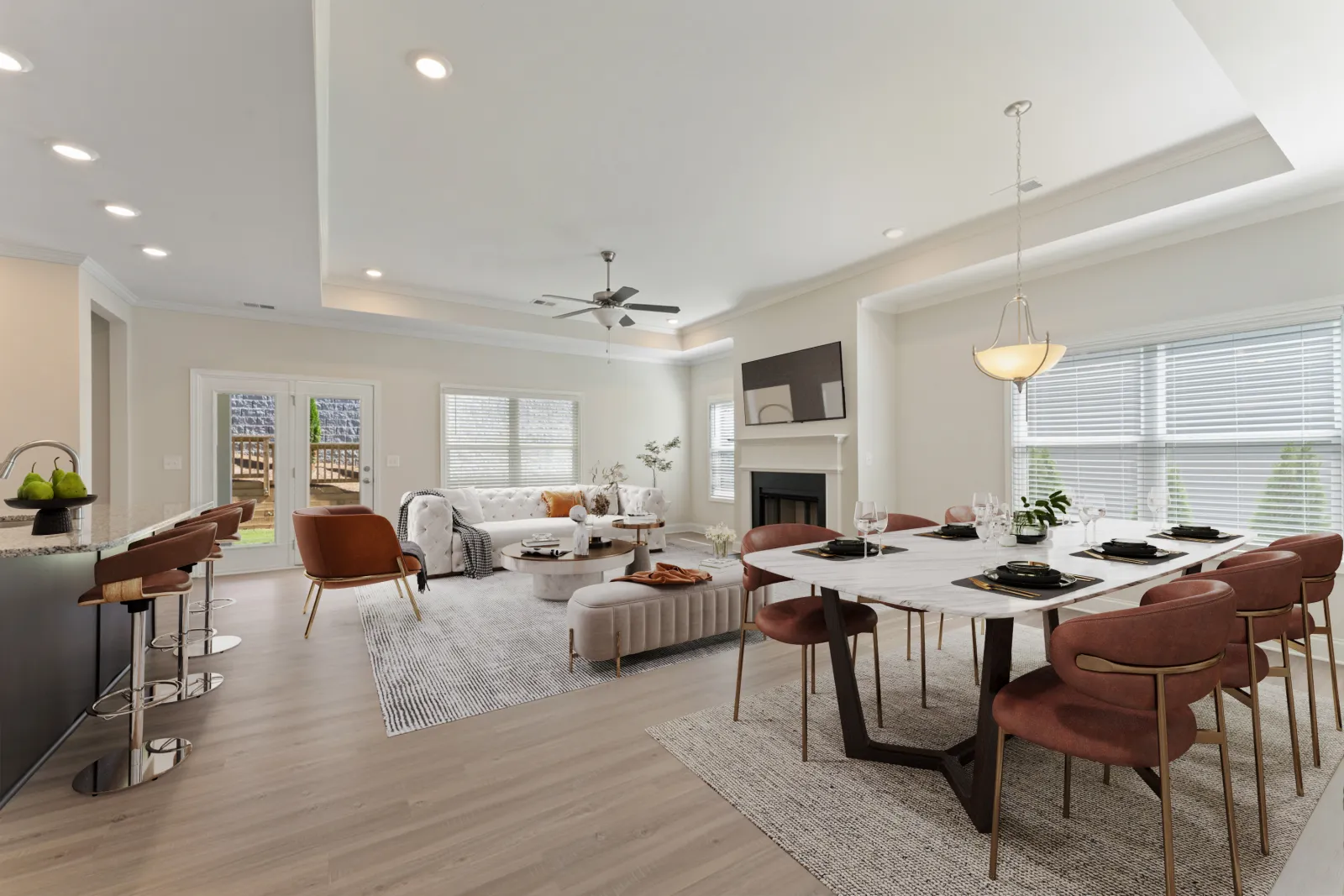 a large living room with a dining table and chairs