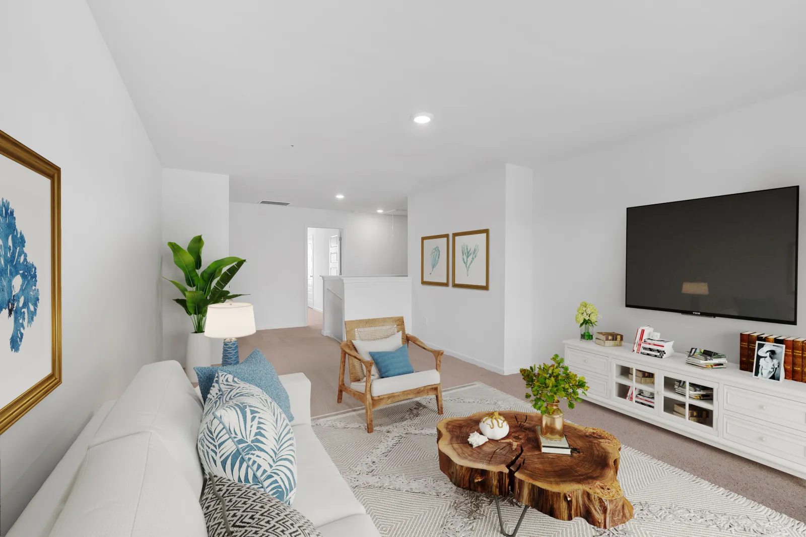 Bright modern living room with white sofa, wooden chair, tree stump coffee table, and large flat-screen TV
